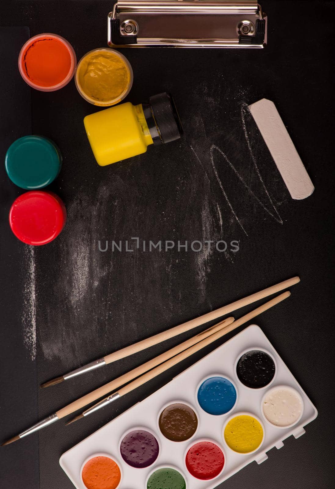 School supplies on blackboard background.