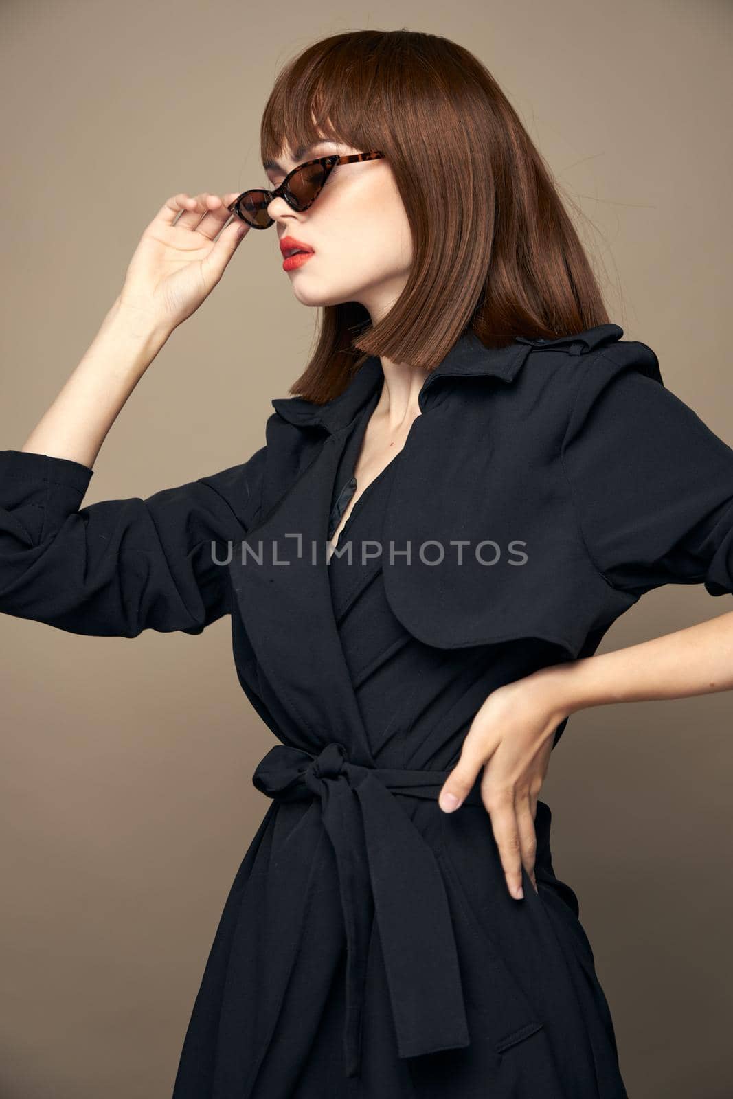 Charming brunette Looks to the side and holds his hand at the waist dark glasses by SHOTPRIME