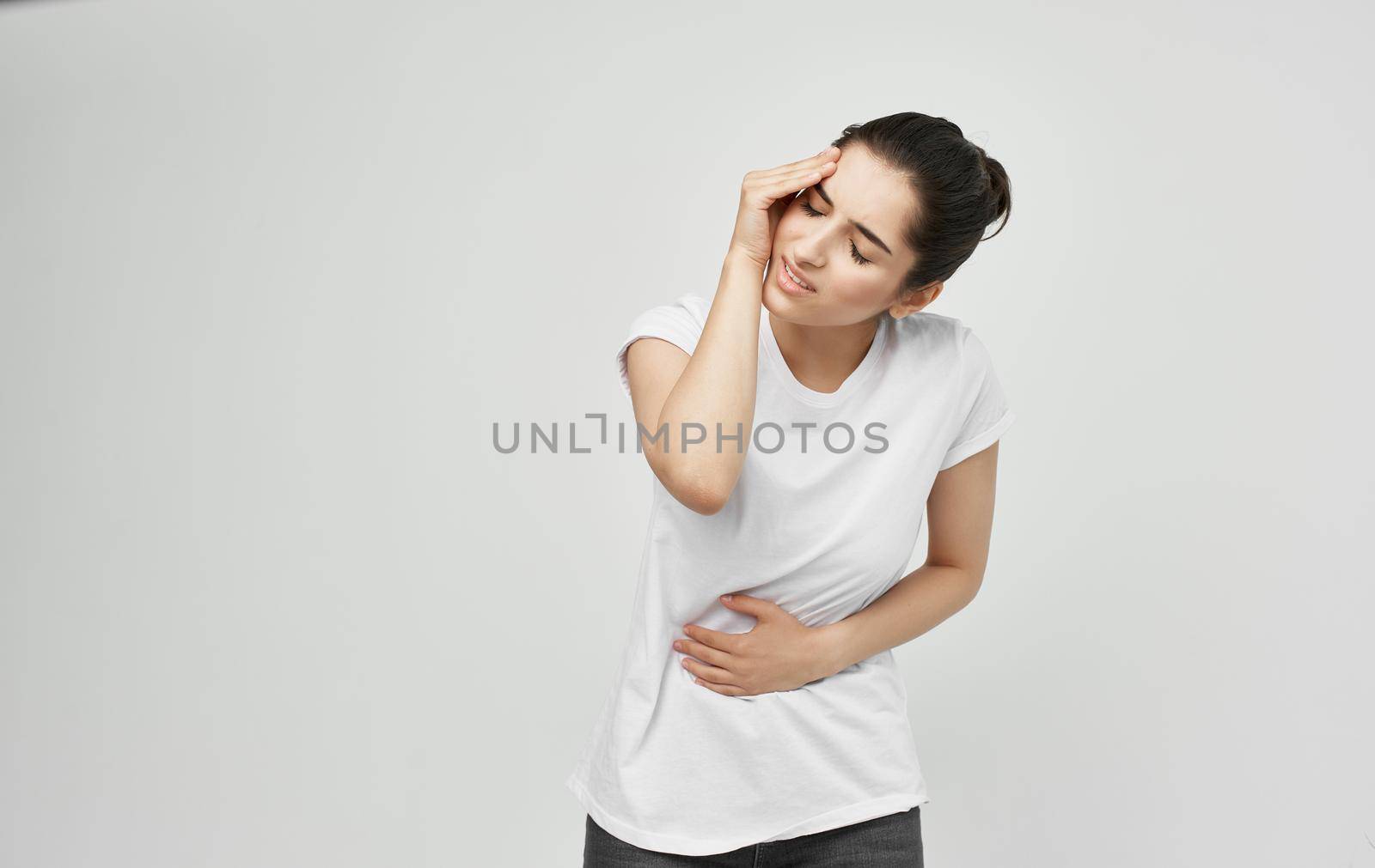 woman in white t-shirt health problems body pain discomfort by SHOTPRIME