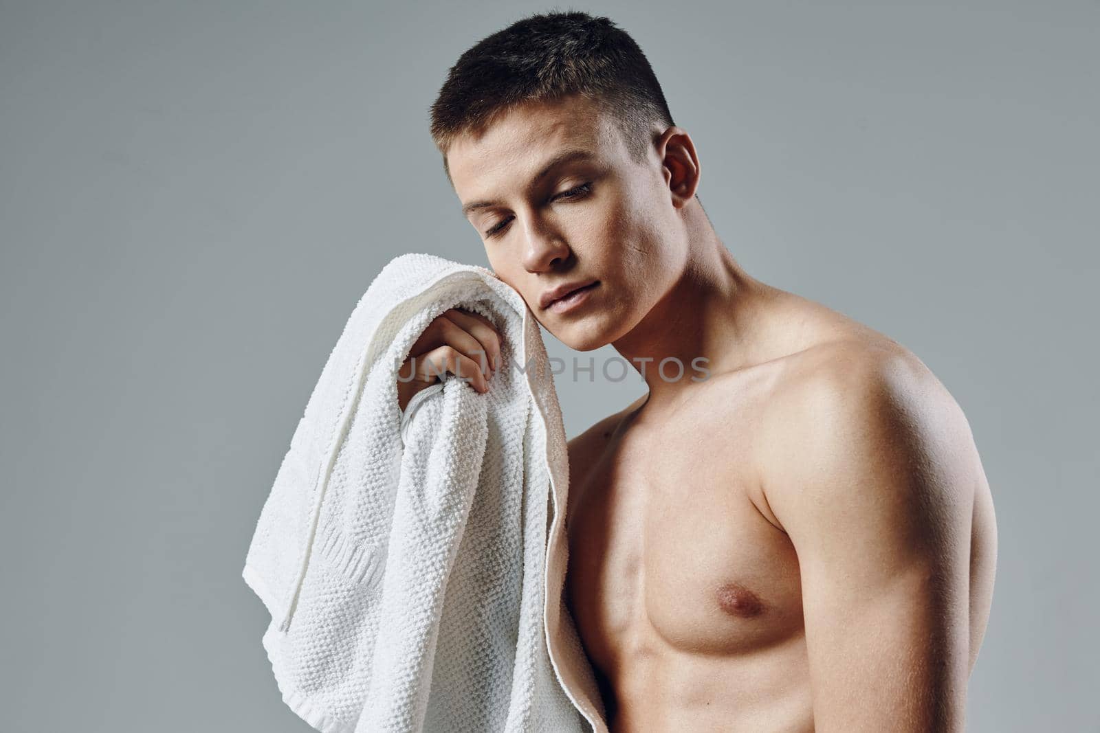 portrait of sporty man with towel in hands cropped view of bodybuilder workout. High quality photo