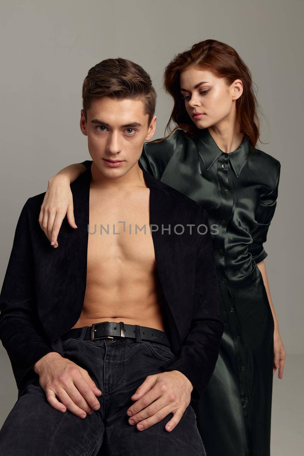 A man with an unbuttoned shirt next to a woman romance luxury attractiveness. High quality photo