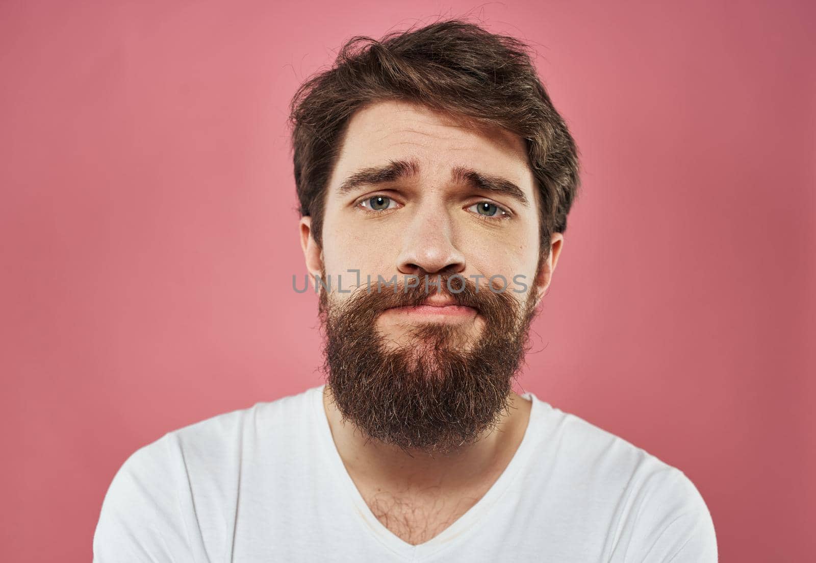Male cropped view portrait of brunet bushy beard white t-shirt by SHOTPRIME