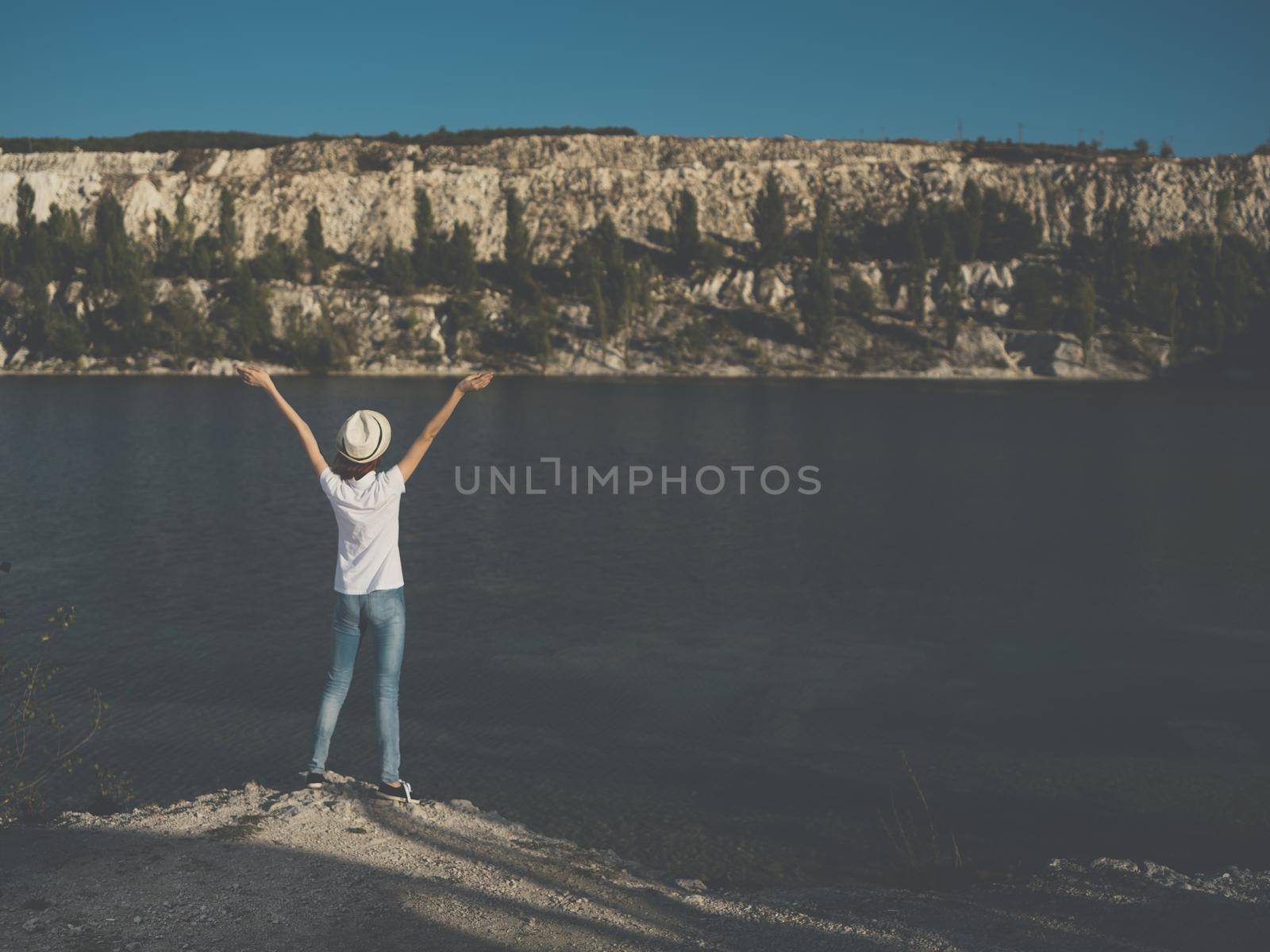 Energetic woman traveler near the river on nature in the mountains by SHOTPRIME