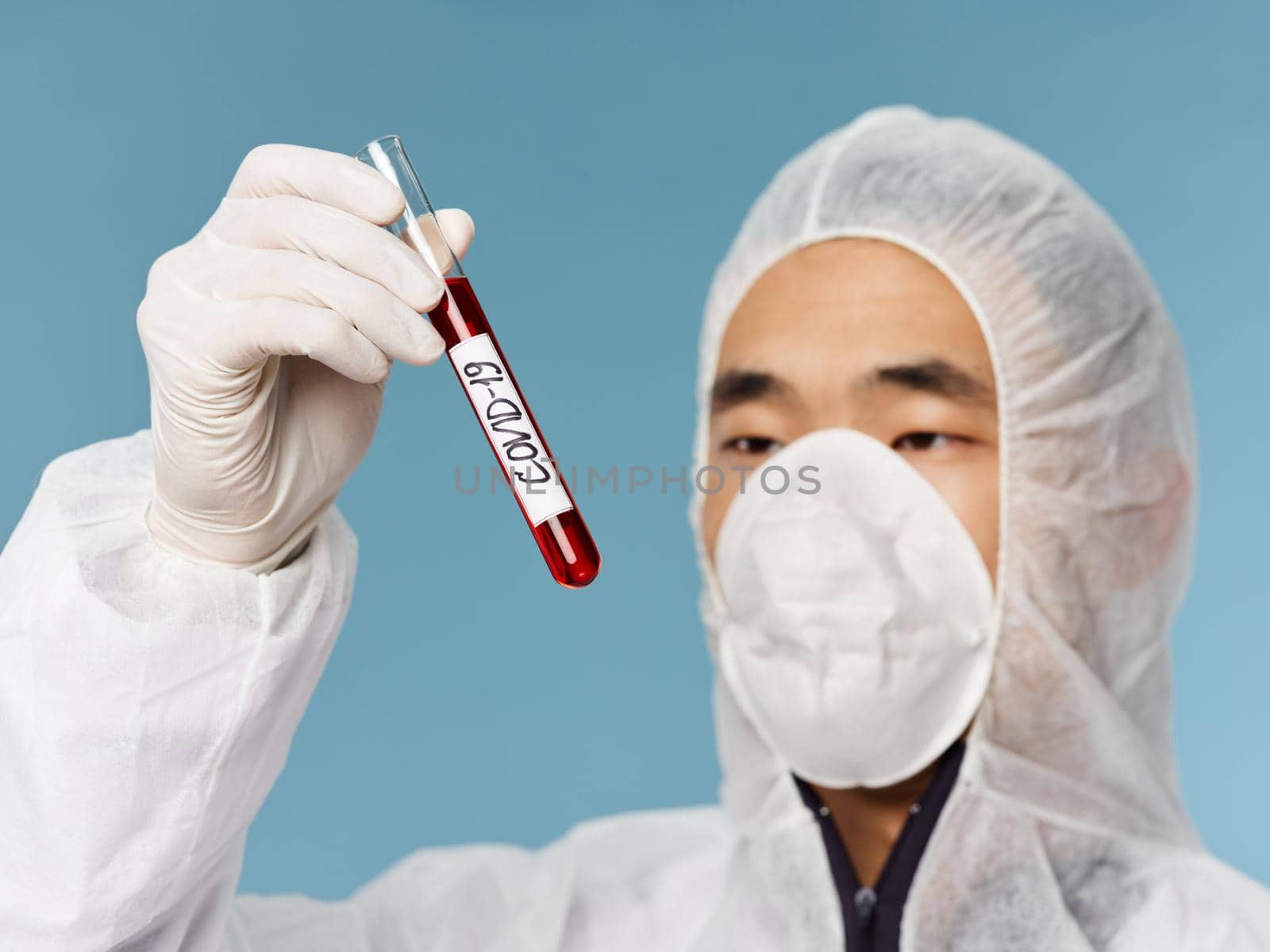 asian man medical mask blood test close up examination blue background diagnostics. High quality photo