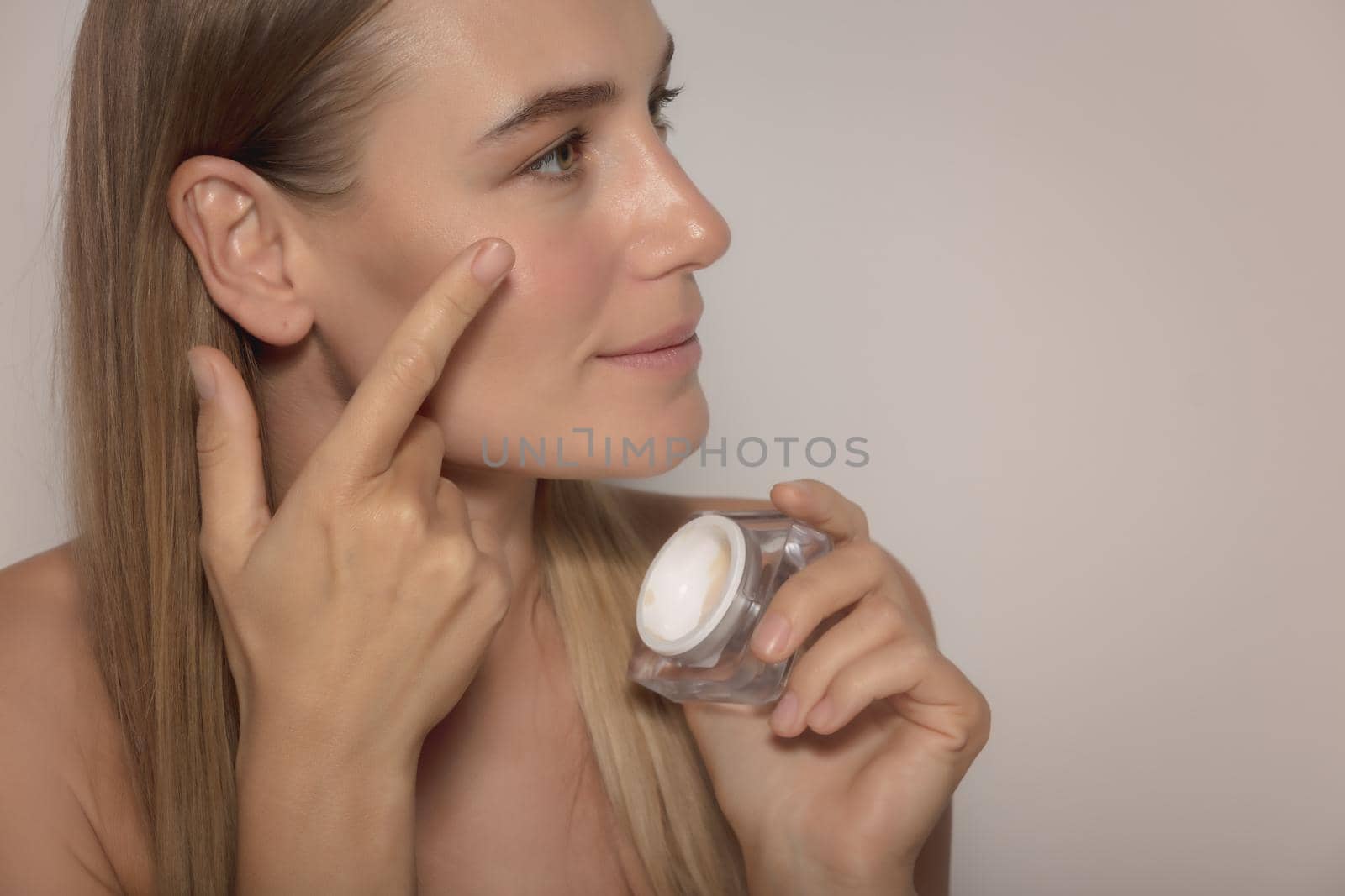 Pretty Girl Applying Face Cream by Anna_Omelchenko