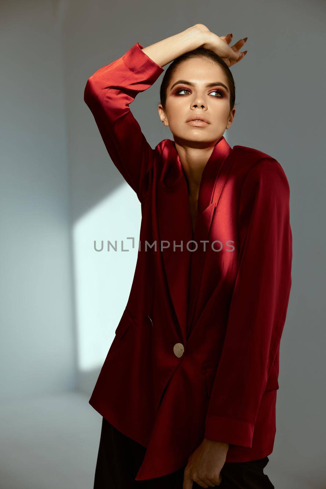 pretty woman in red jacket bright makeup studio luxury. High quality photo