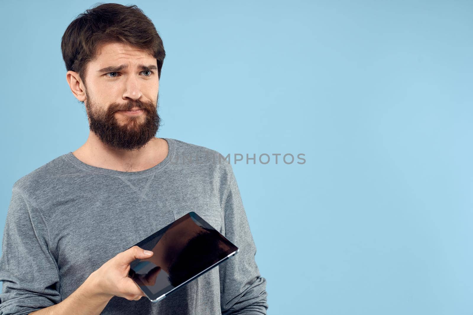 A bearded man with a tablet in the hands of technology Professional Internet communication by SHOTPRIME