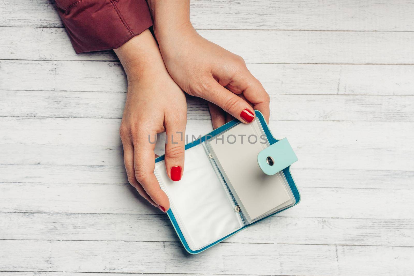 blue business card wallet and wooden table female lessons bright nails by SHOTPRIME