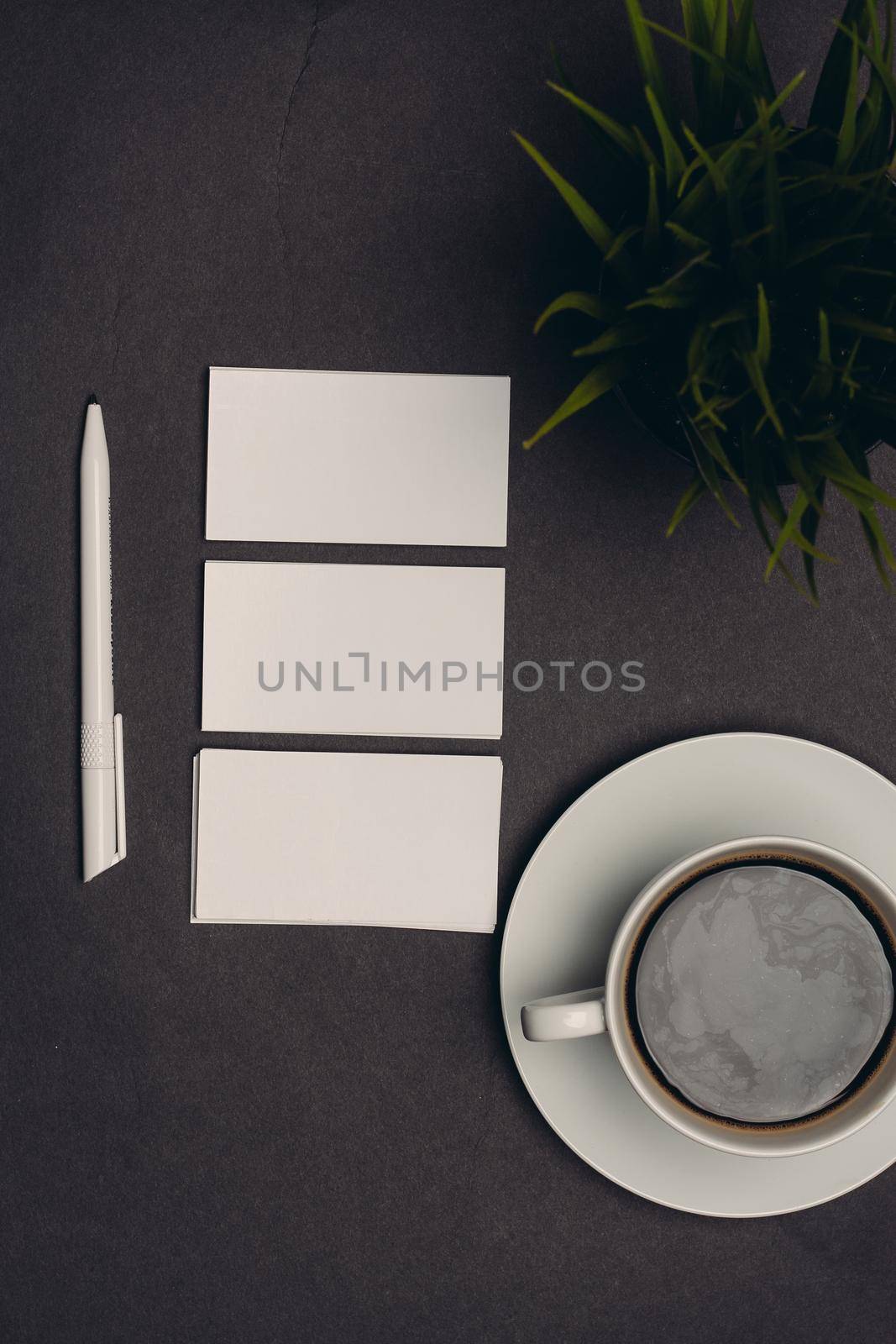 white business cards on dark table and office finance. High quality photo