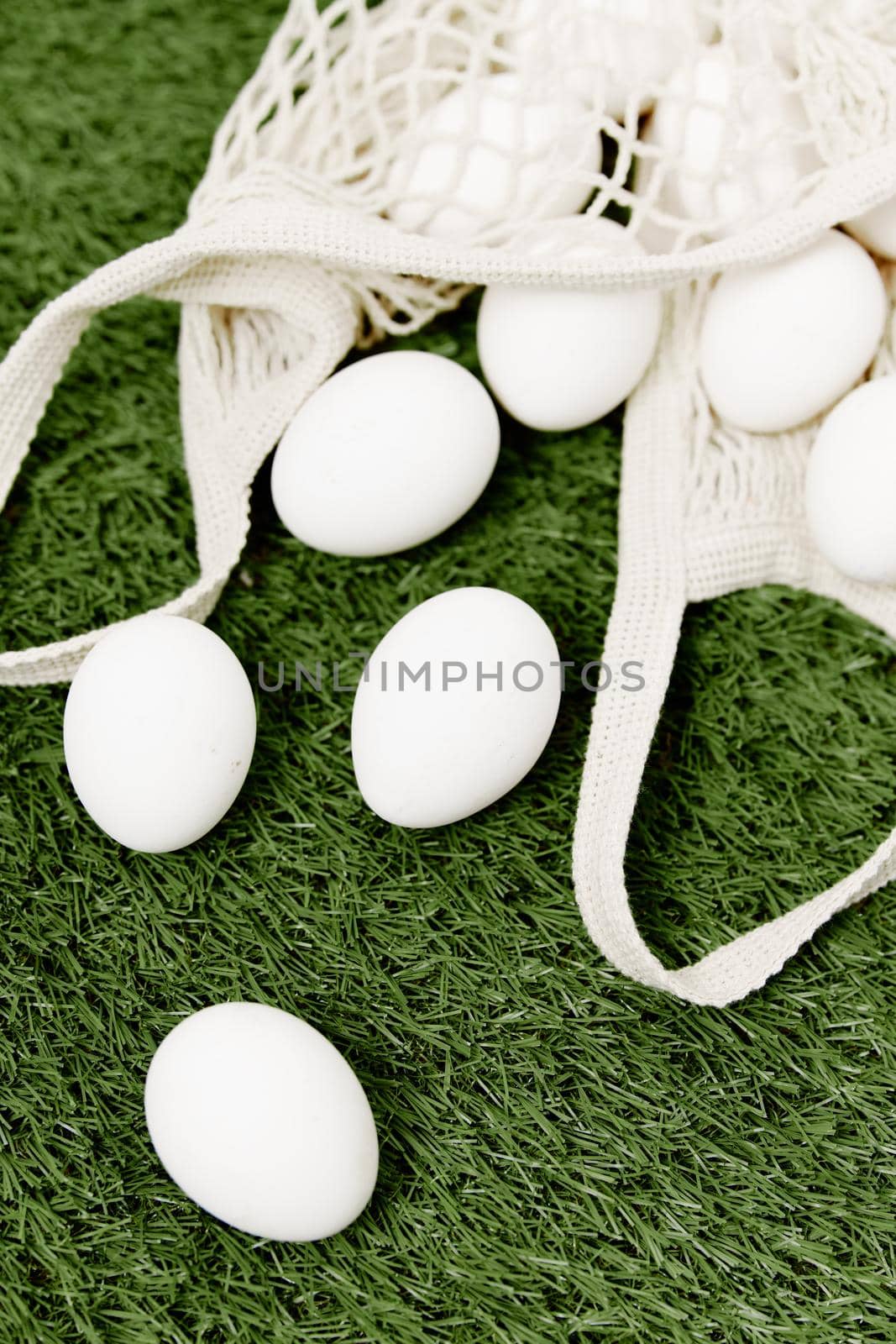 scattered eggs on a green lawn Easter day holiday close-up by SHOTPRIME