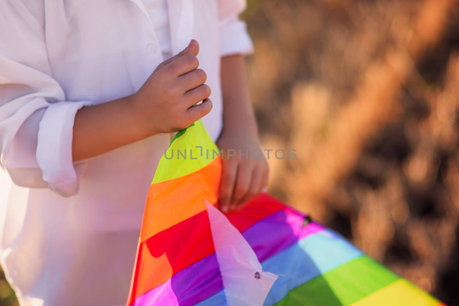 A kite in the hands of a boy close-up. Selective focusing.