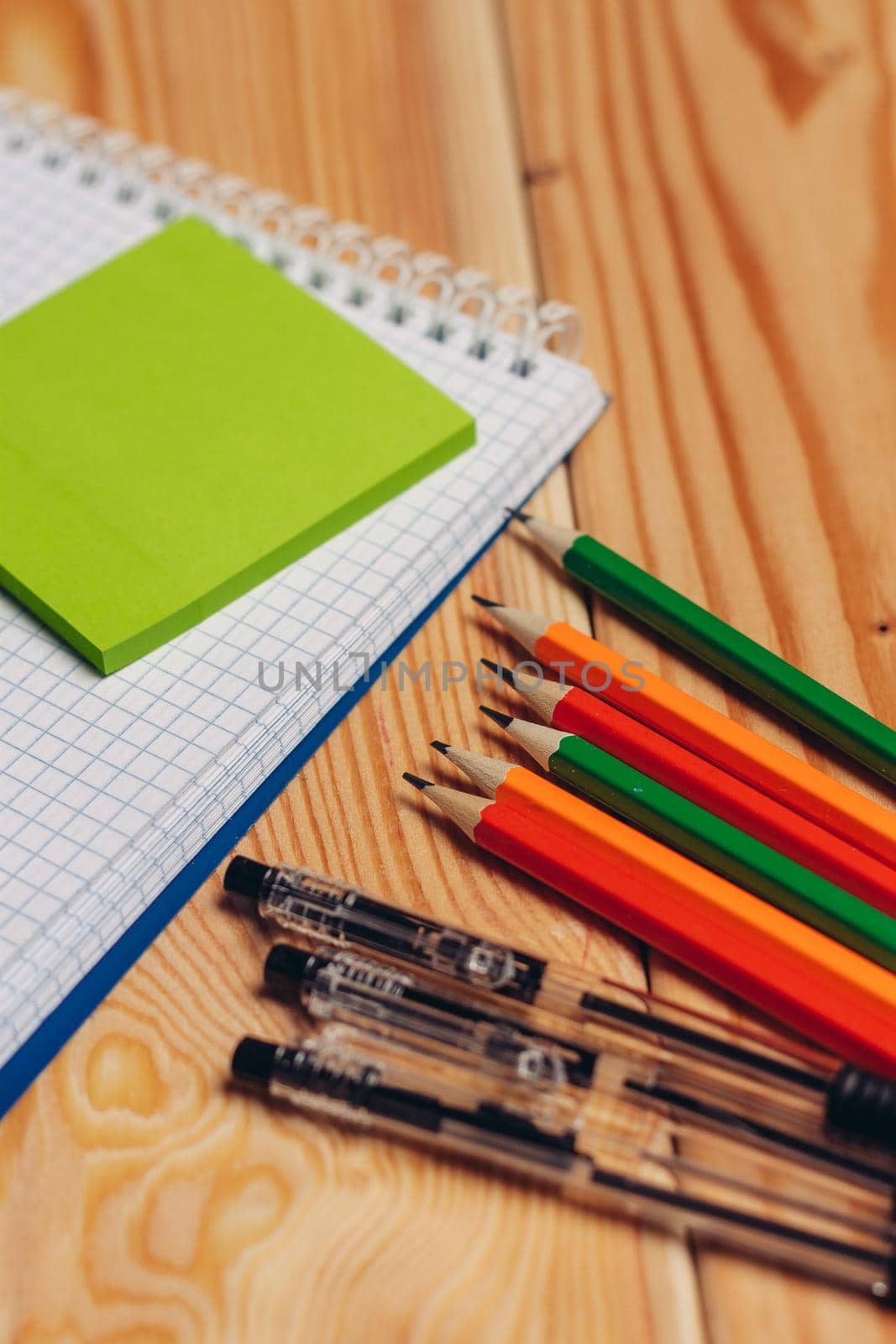 notepads pencils stationery school items work desk top view by SHOTPRIME