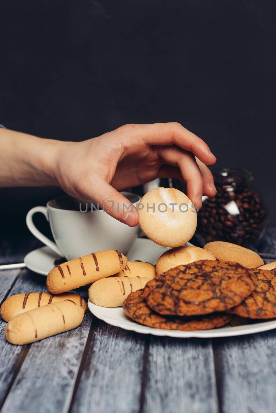 sweet biscuits on a plate a cup with a drink candy Dessert snack. High quality photo