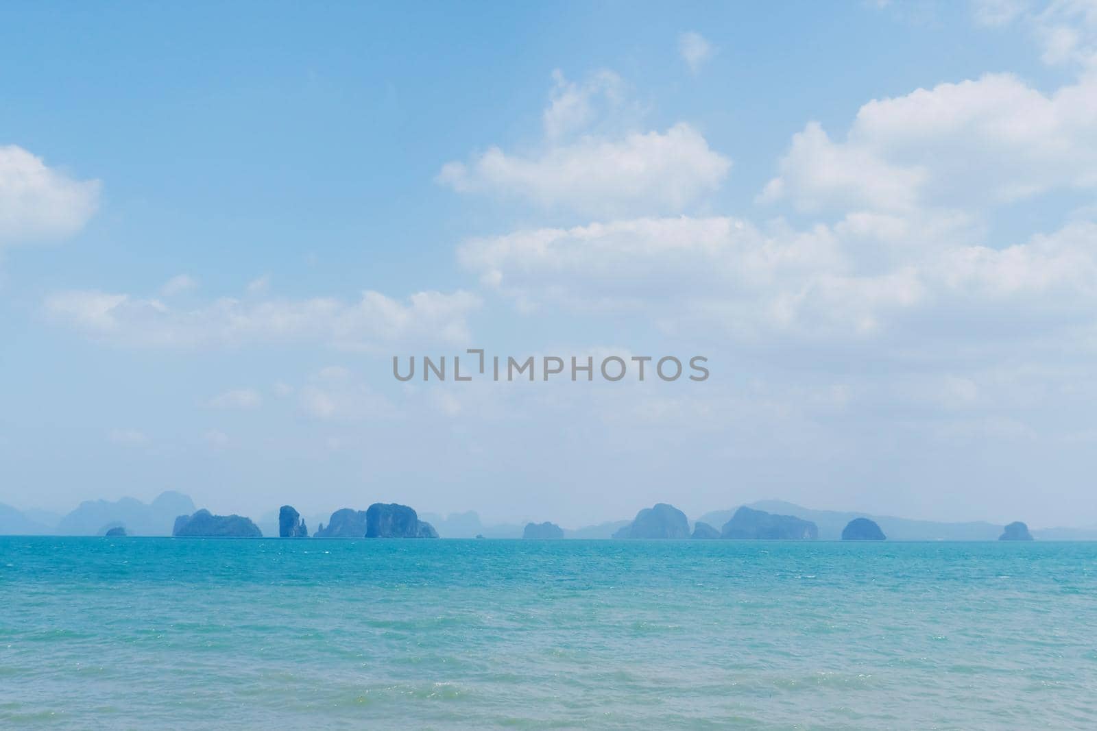 Tropical nature clean beach and white sand in summer season with sun light blue sky background.