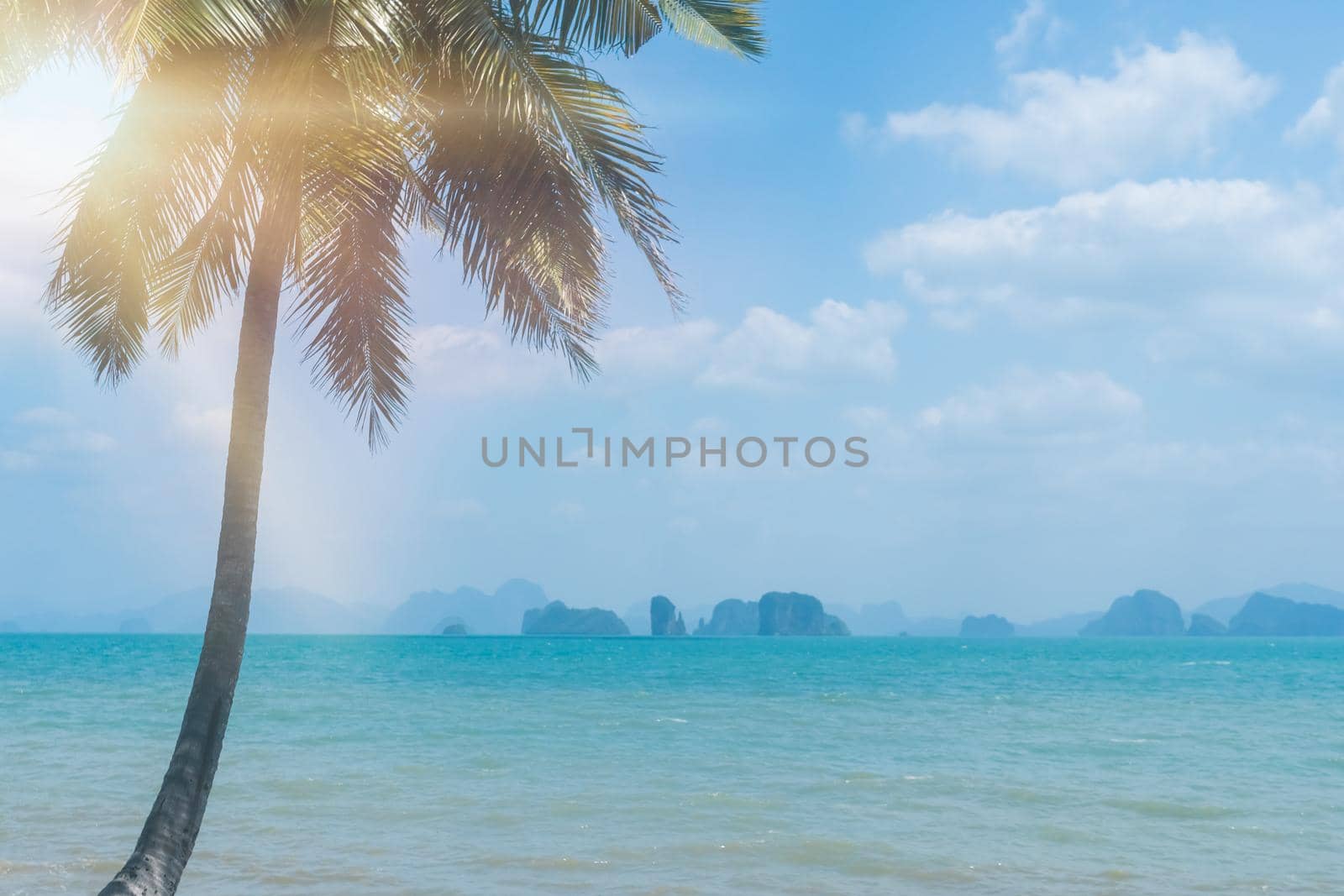 Tropical nature clean beach and white sand in summer season with sun light blue sky background.