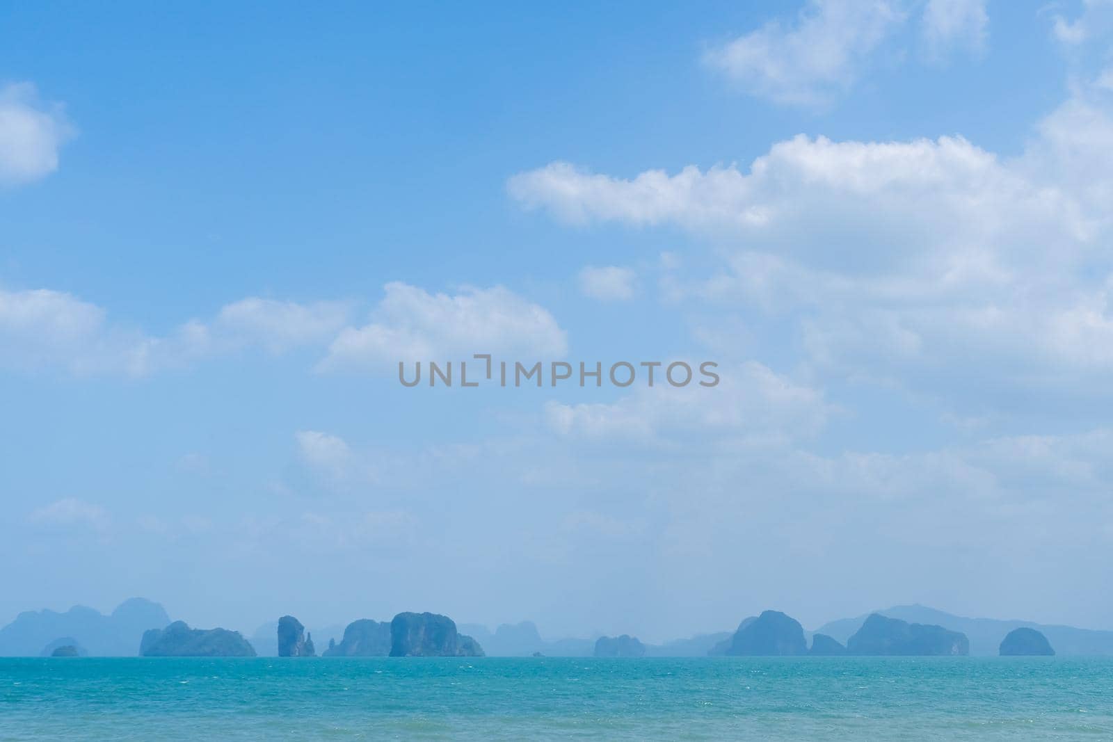 Tropical nature clean beach and white sand in summer season with sun light blue sky background.