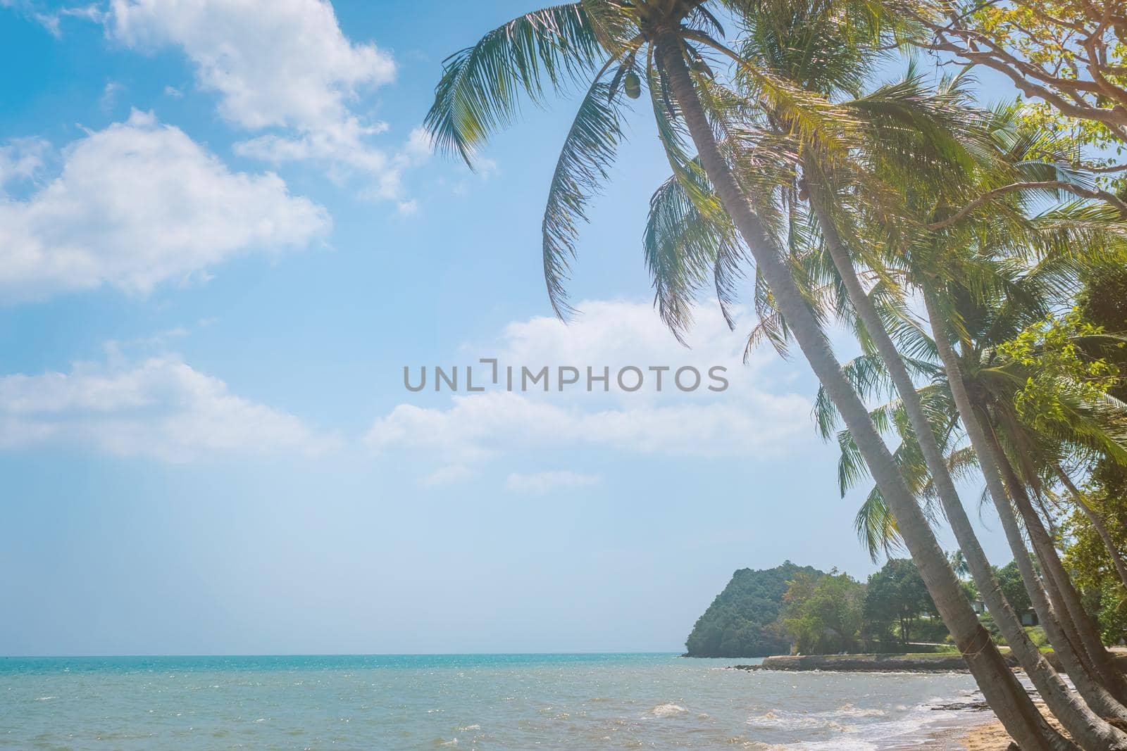 Tropical nature clean beach and white sand in summer season with sun light blue sky background.