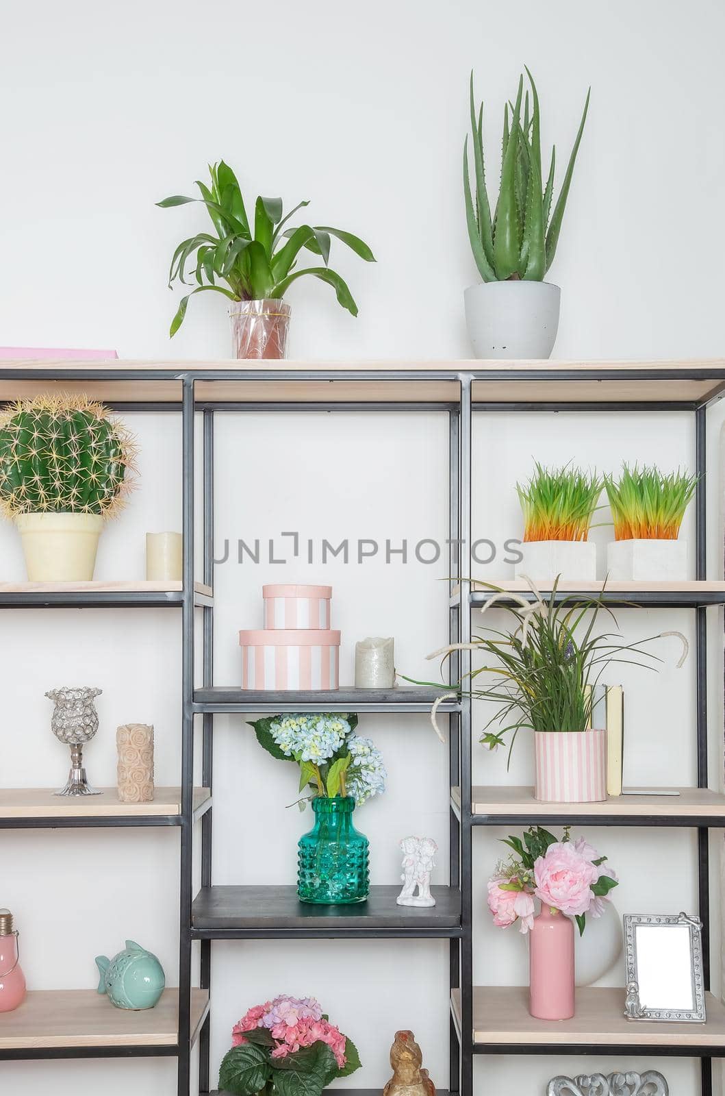 Flowers and decorative decorations on a metal rack in the style of minimalism in the living room in a Scandinavian style