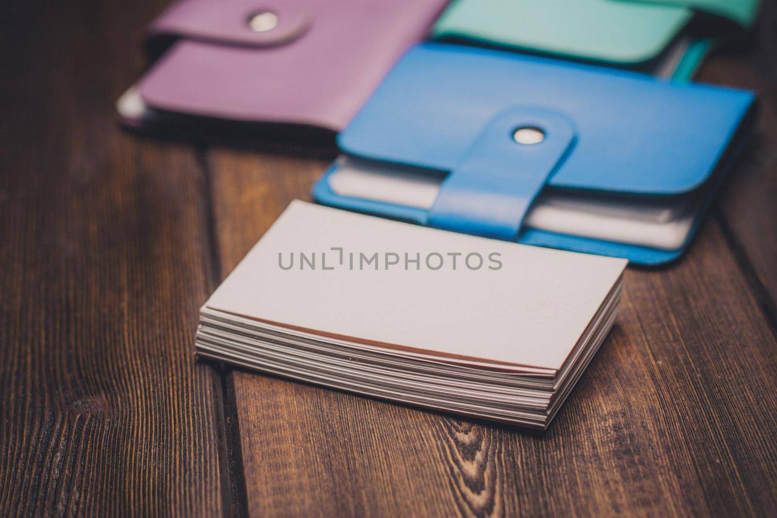 a pack of business cards and wallets for money on a wooden background side view. High quality photo
