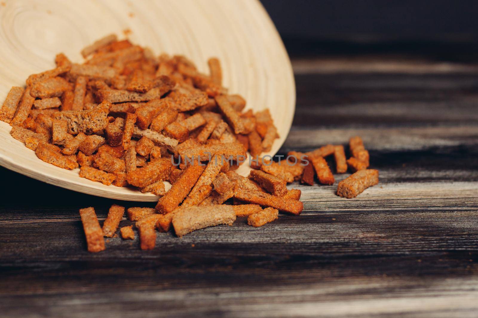 croutons on a plate snacks for beer snack wooden table. High quality photo