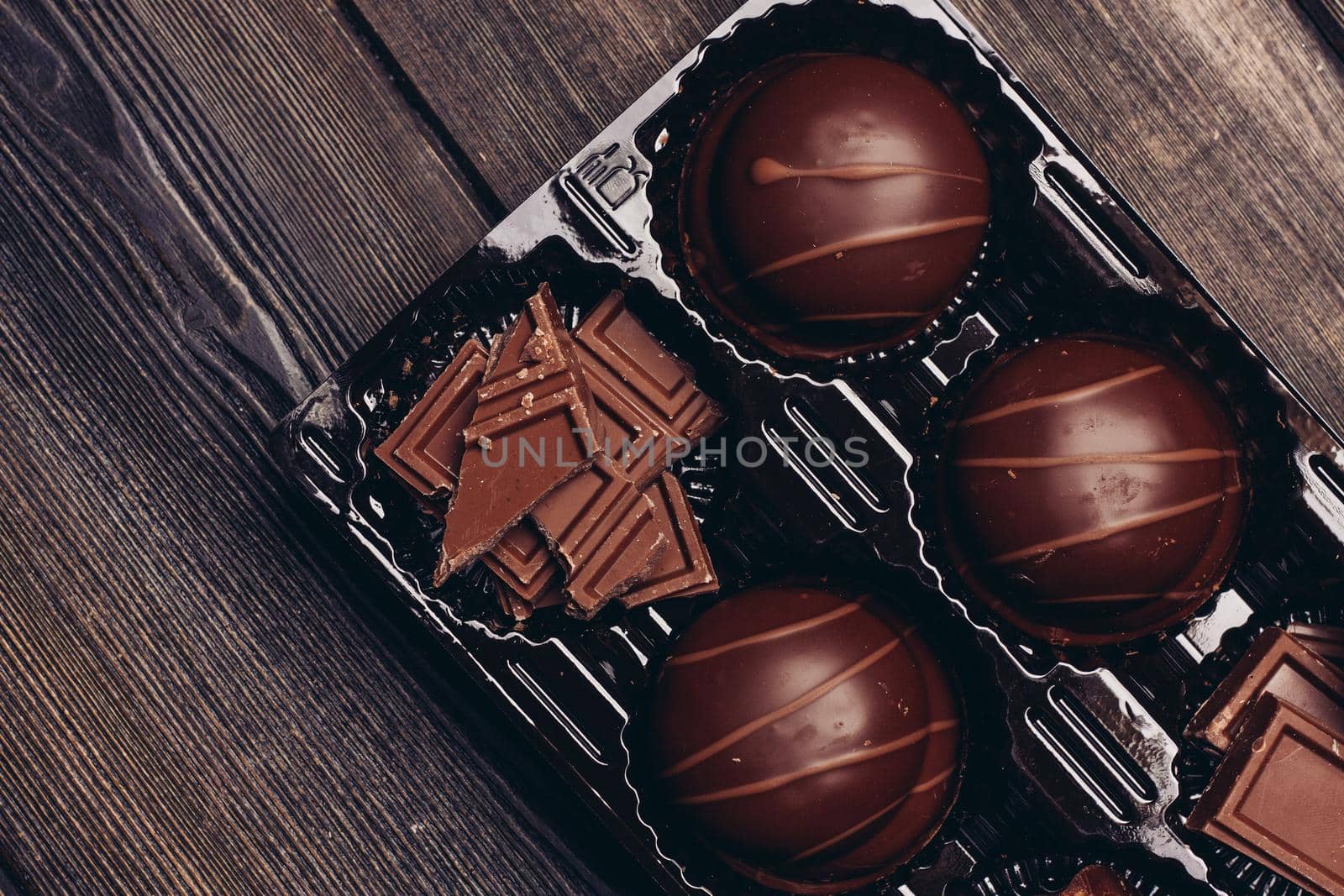 cakes sweets sweets and chocolate cubes on a wooden table. High quality photo