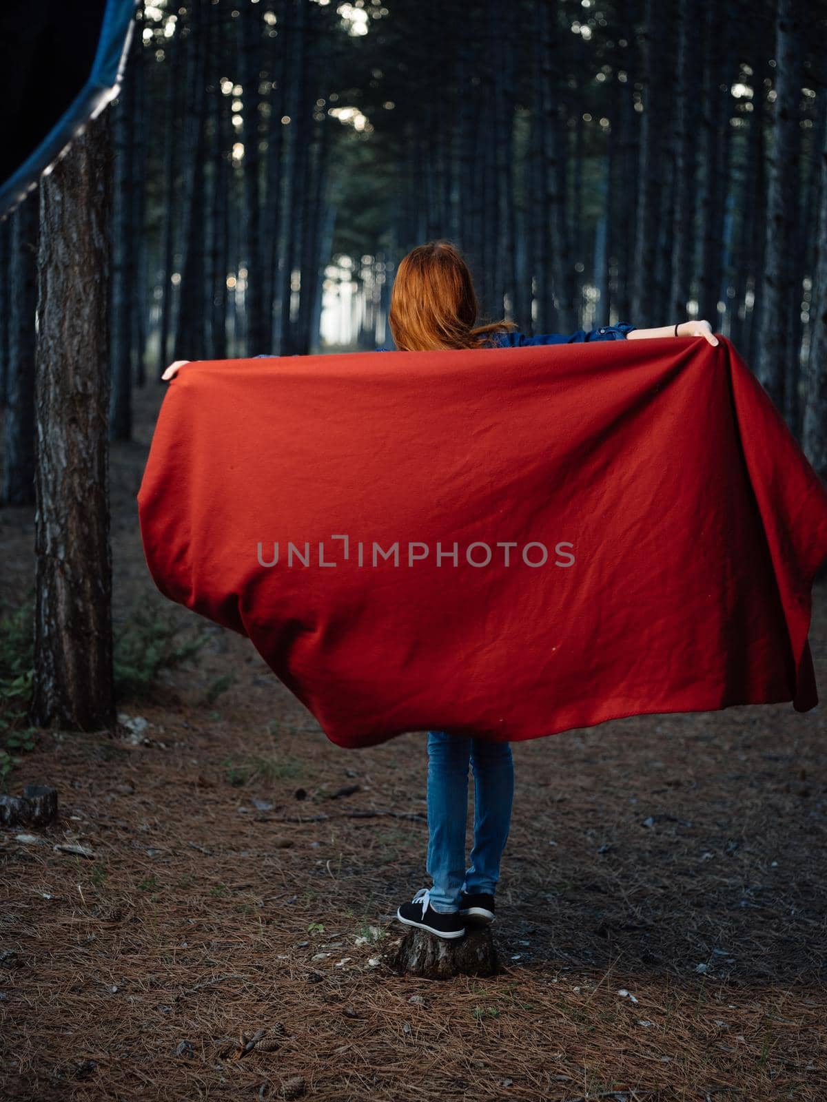 A woman with a red plaid on her shoulders among the trees by SHOTPRIME