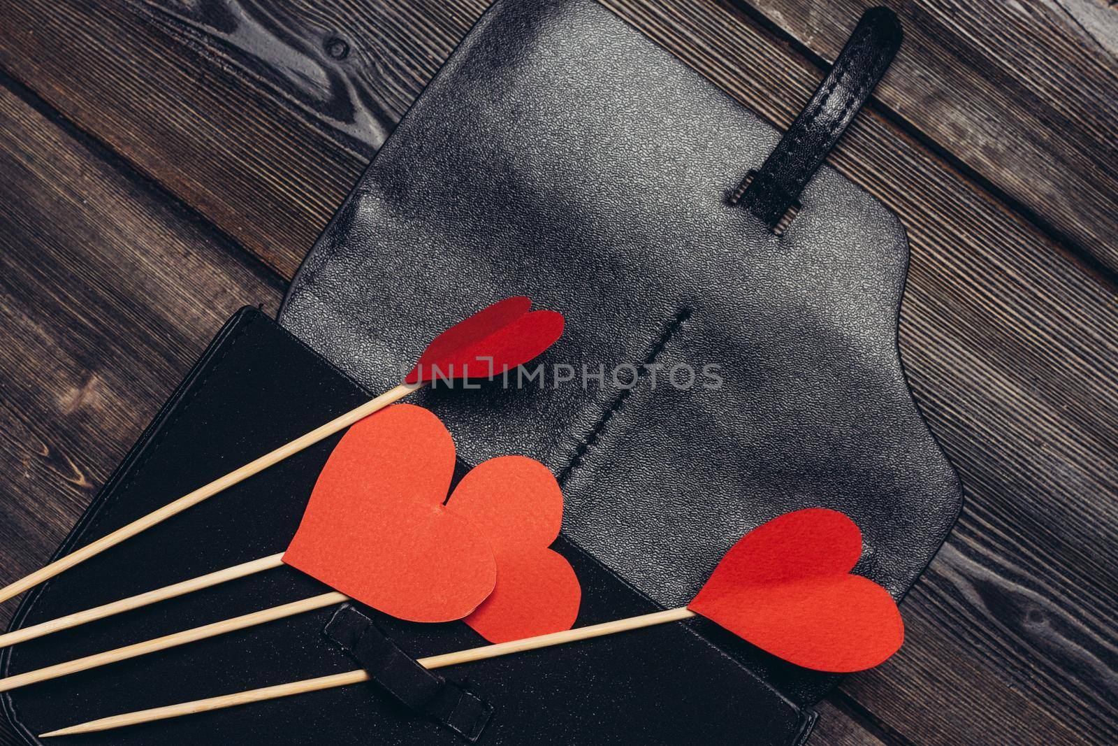 leather business card holder red heart ornament decoration wooden table. High quality photo