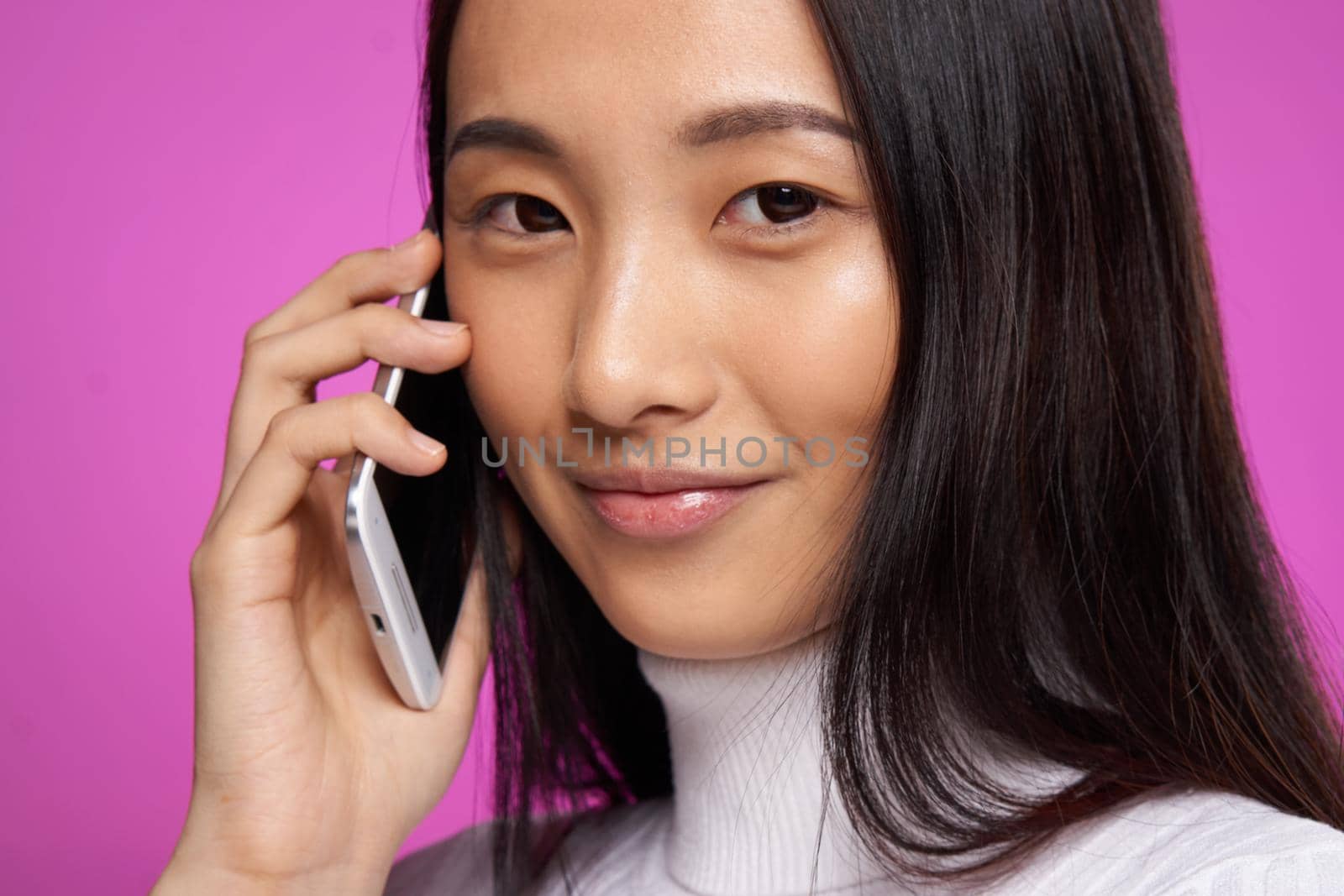 woman asian appearance phone communication internet lifestyle pink background. High quality photo