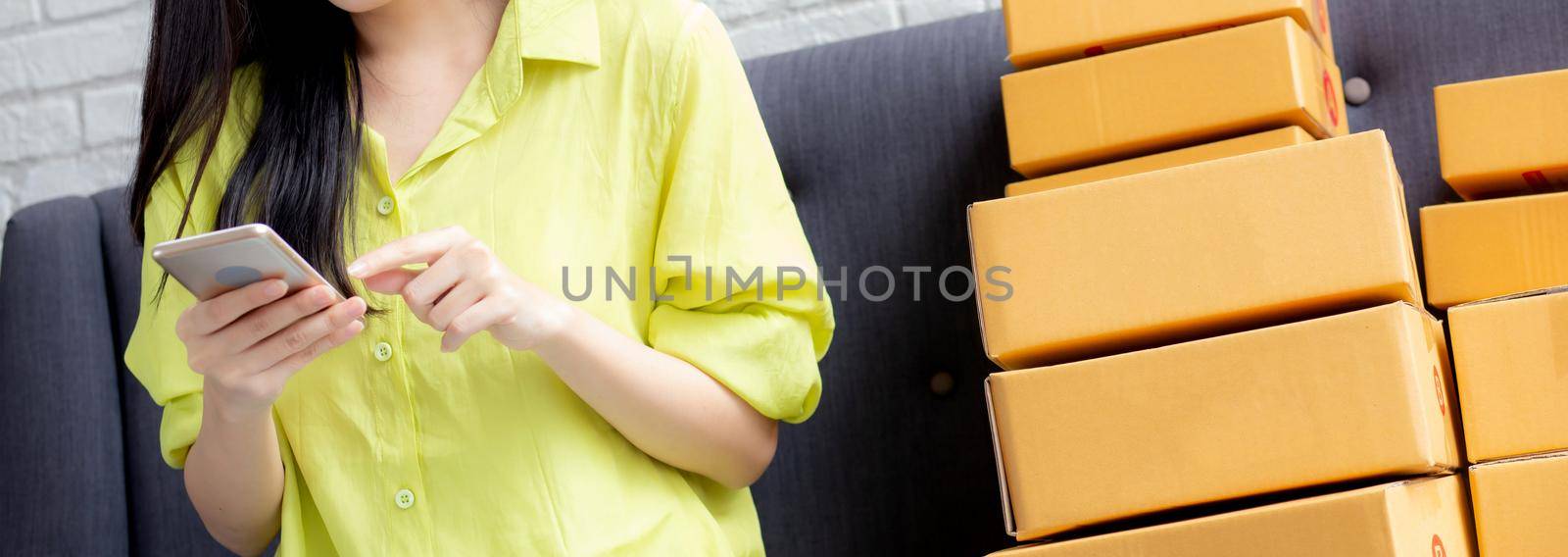 Closeup hand of young asian woman is entrepreneur check order from phone with customer while purchase online, logistic and delivery, online shopping, female is seller of business SME.