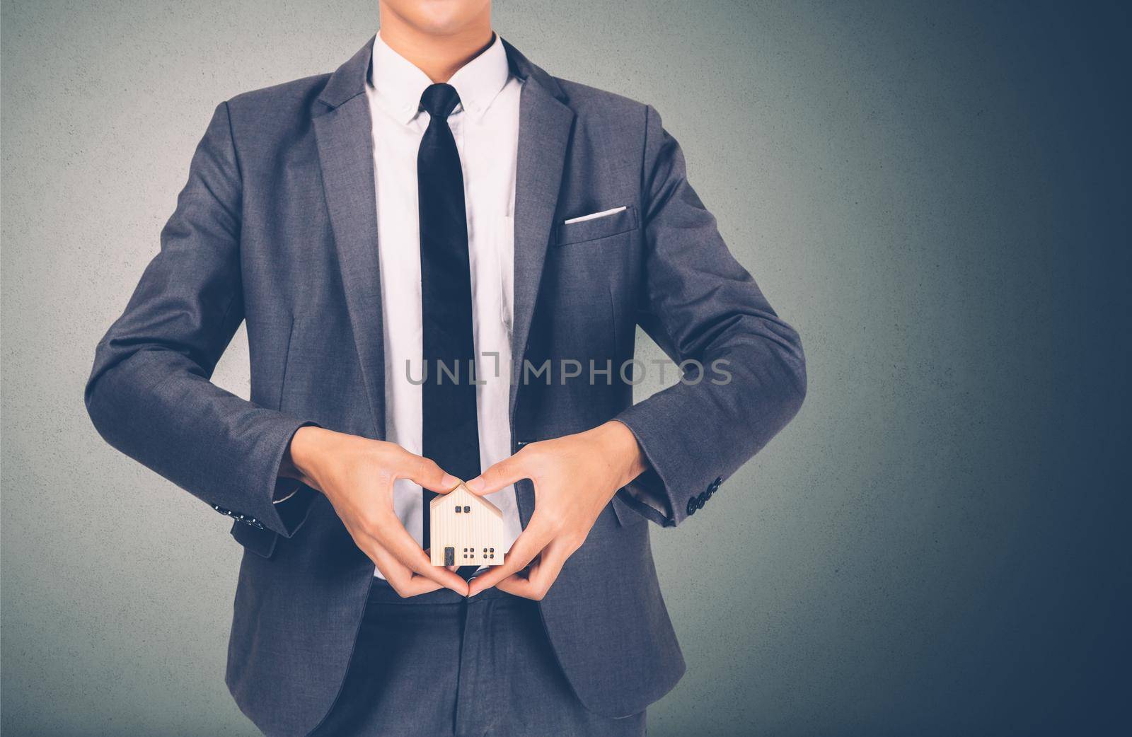 Hand holding the home and symbol heart shape of saving for future, insurance agent and credit, debt and loan of finance, purchase home and refinance, investment about real property, business concept.