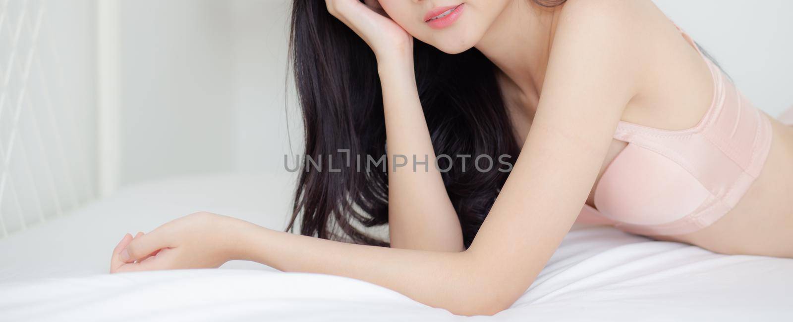 Beautiful young asian woman sexy in underwear figure fit relax in bedroom, asia girl body slim in lingerie confident and happy lying on bed in bedchamber, lifestyle concept, banner website.
