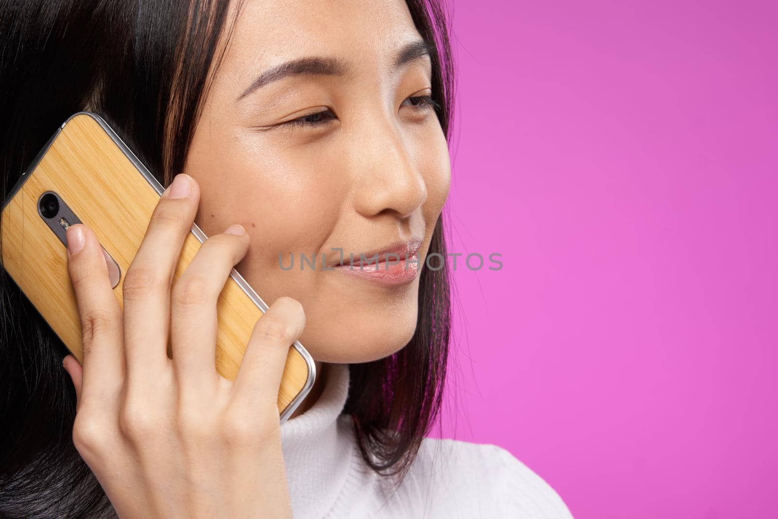 woman asian appearance phone close-up smile pink technology background by SHOTPRIME