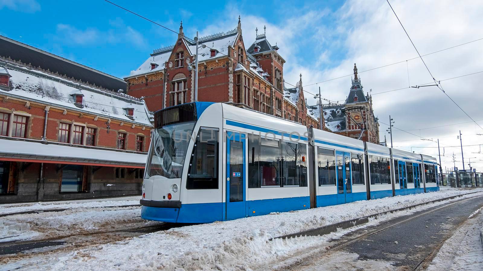 Tram waiting in winter in front of the Central Station in Amsterdam the Netherlands by devy