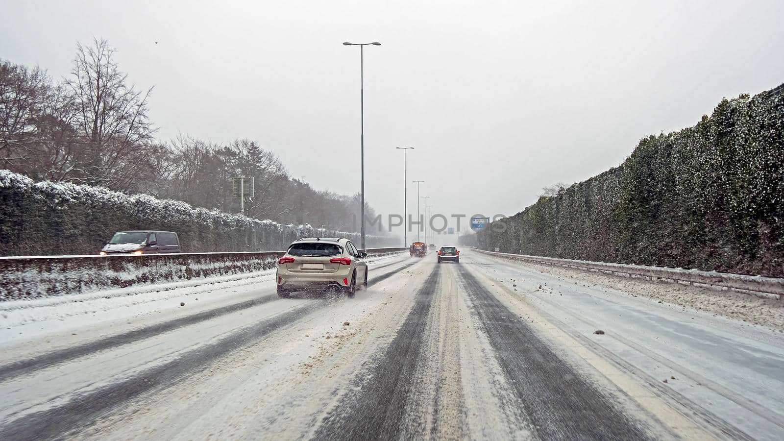 Driving on the highway A1 during a snowstorm in winter in the Netherlands by devy