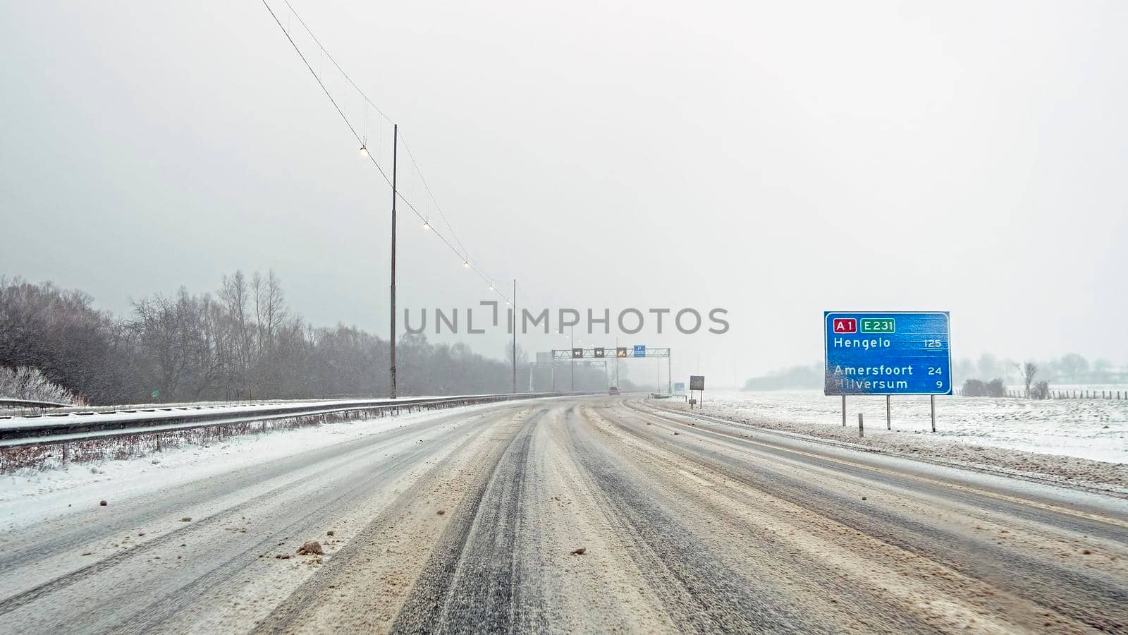 Driving on the highway A1 during a snowstorm in winter in the Netherlands