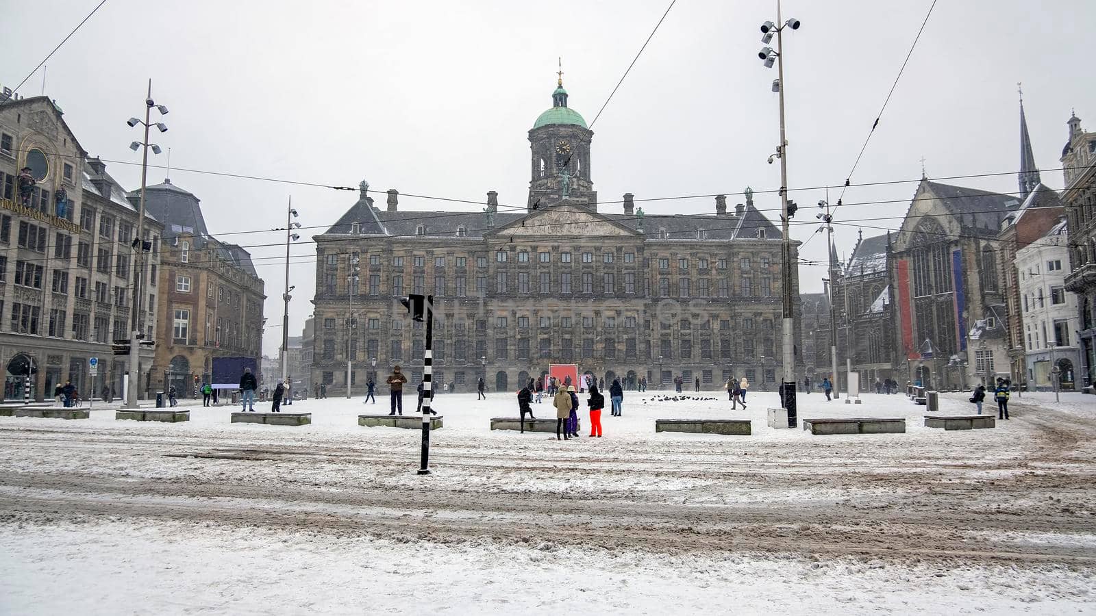 Snowy city Amsterdam at the Dam square in the Netherlands in winter by devy