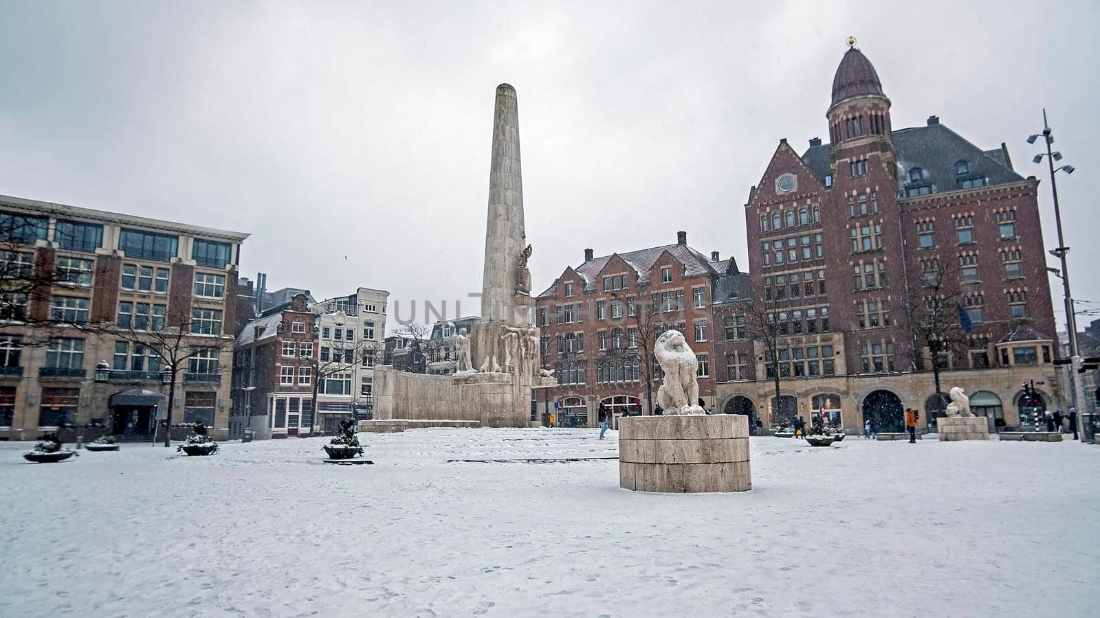Snowy city Amsterdam at the Dam square in the Netherlands in winter by devy