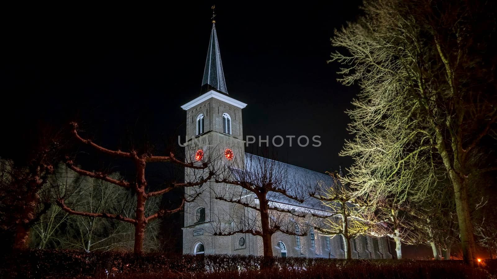 Snowy medieval church in Ternaard Friesland in the Netherlands at night