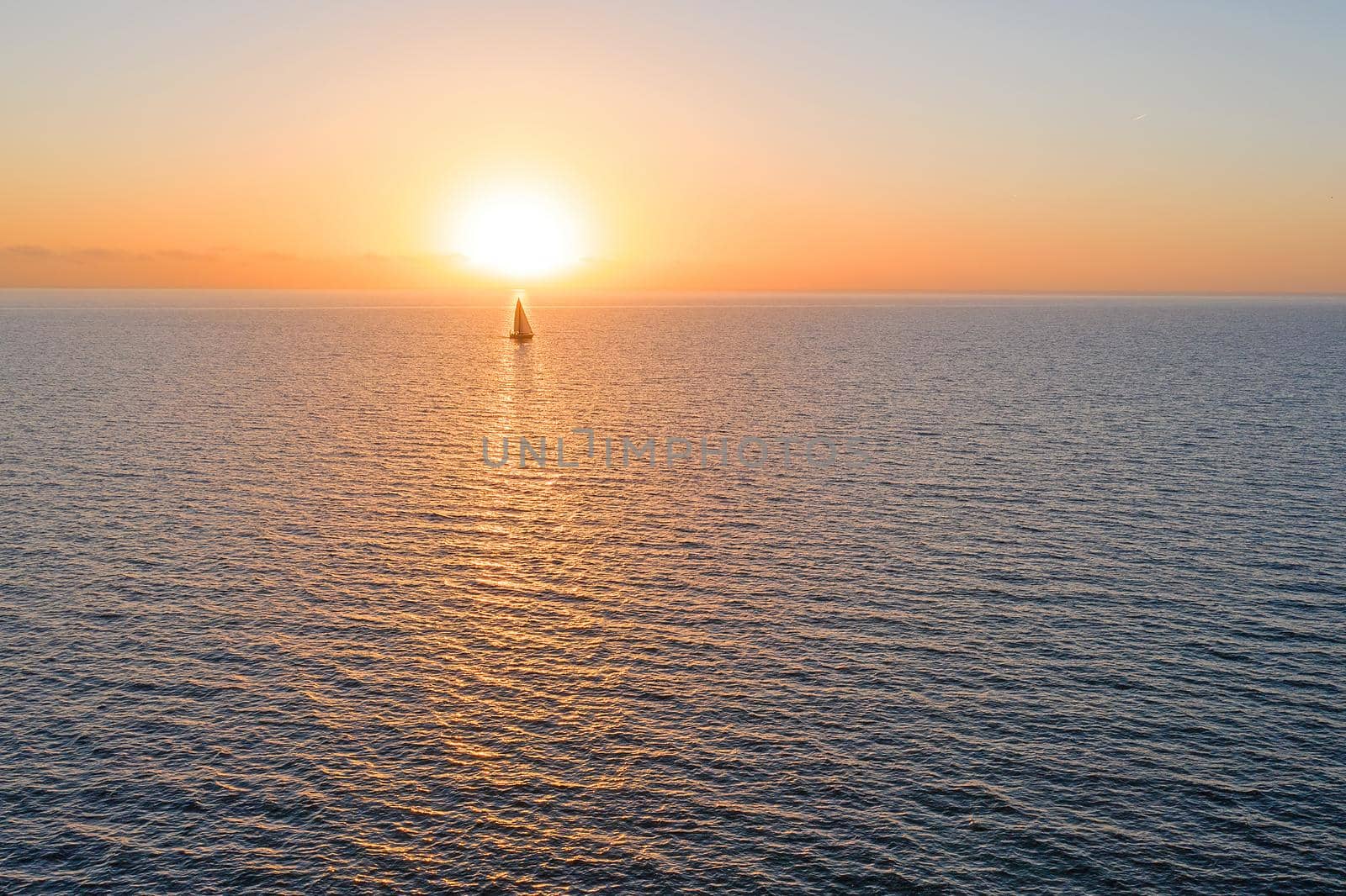 Aerial from sailing on the ocean at sunset