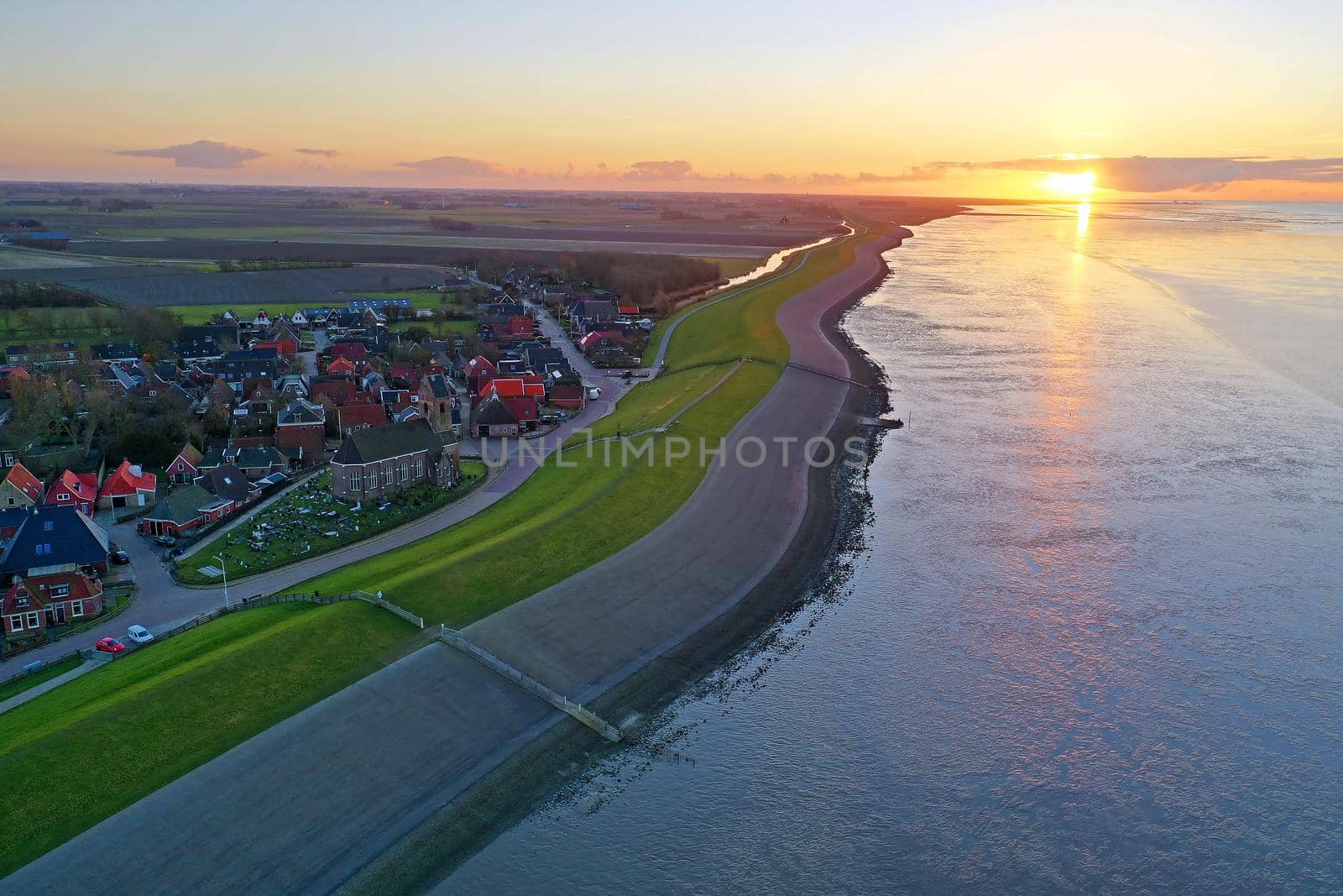 Aerial from the little village Wierum at sunset in Friesland the Netherlands