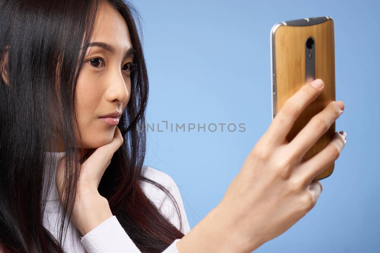 woman of asian appearance with phone in hands communicating internet lifestyle technology. High quality photo