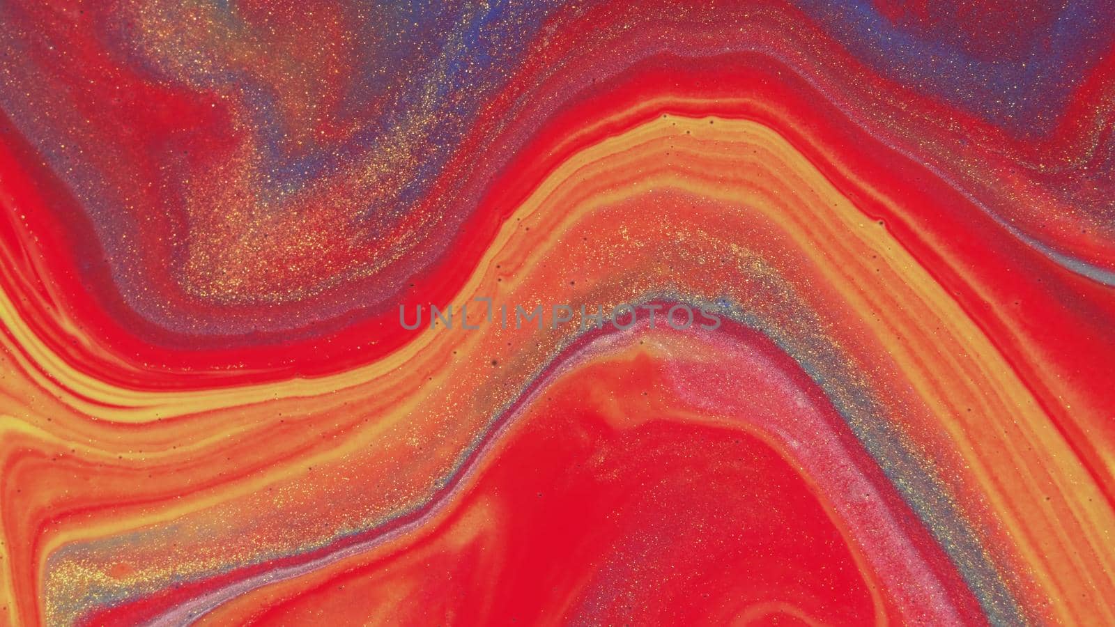 Abstract colorful background of spreading colors. Abstract red paint background. Acrylic texture with marble pattern. Abstract-ART. Natural luxury. The style includes the vortices of marble or the ripples. Very beautiful red, black, yellow, gray, blue paint with the addition of gold powder.