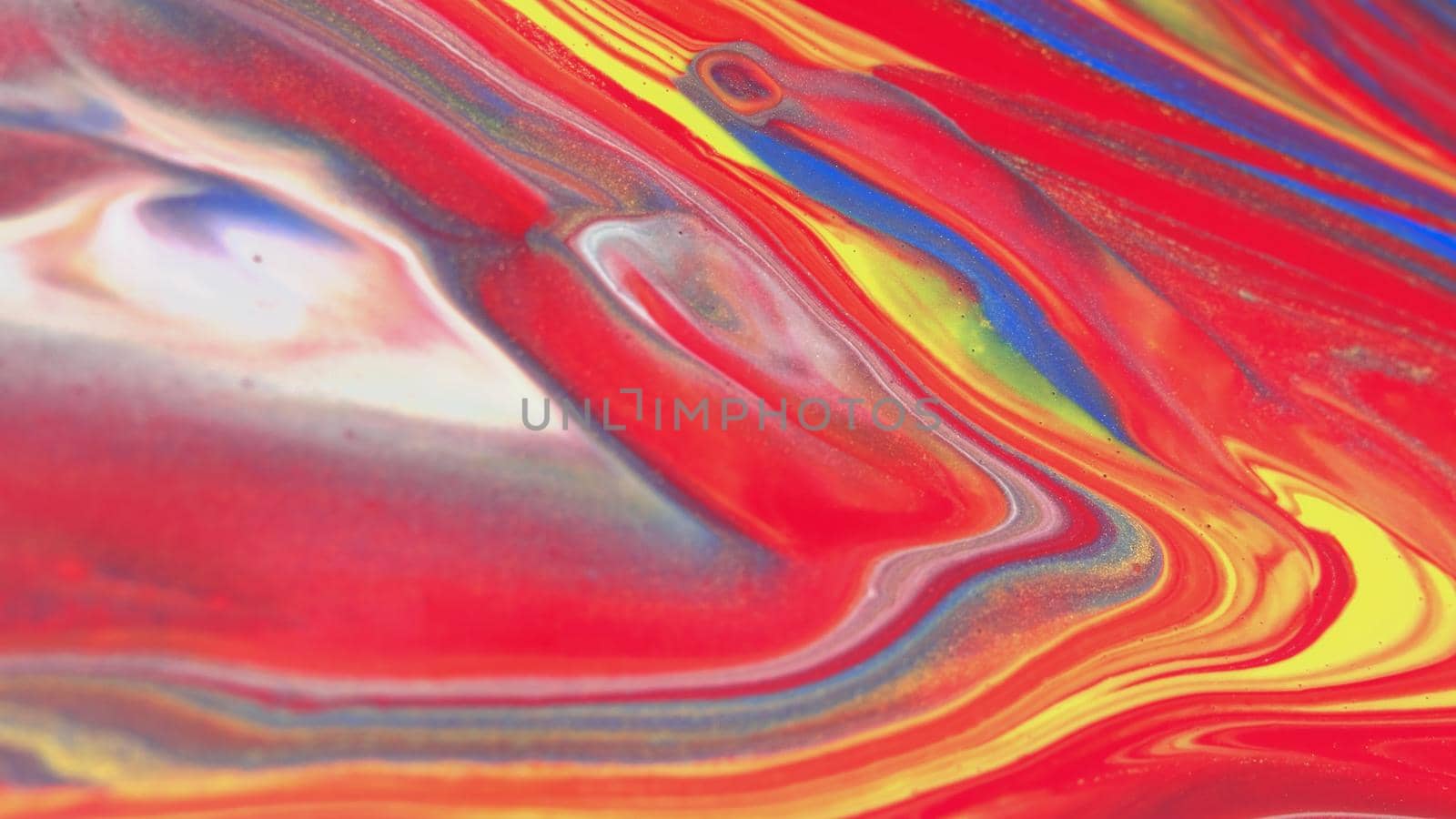 Abstract colorful background of spreading colors. Abstract red paint background. Acrylic texture with marble pattern. Abstract-ART. Natural luxury. The style includes the vortices of marble or the ripples. Very beautiful red, black, yellow, gray, blue paint with the addition of gold powder.