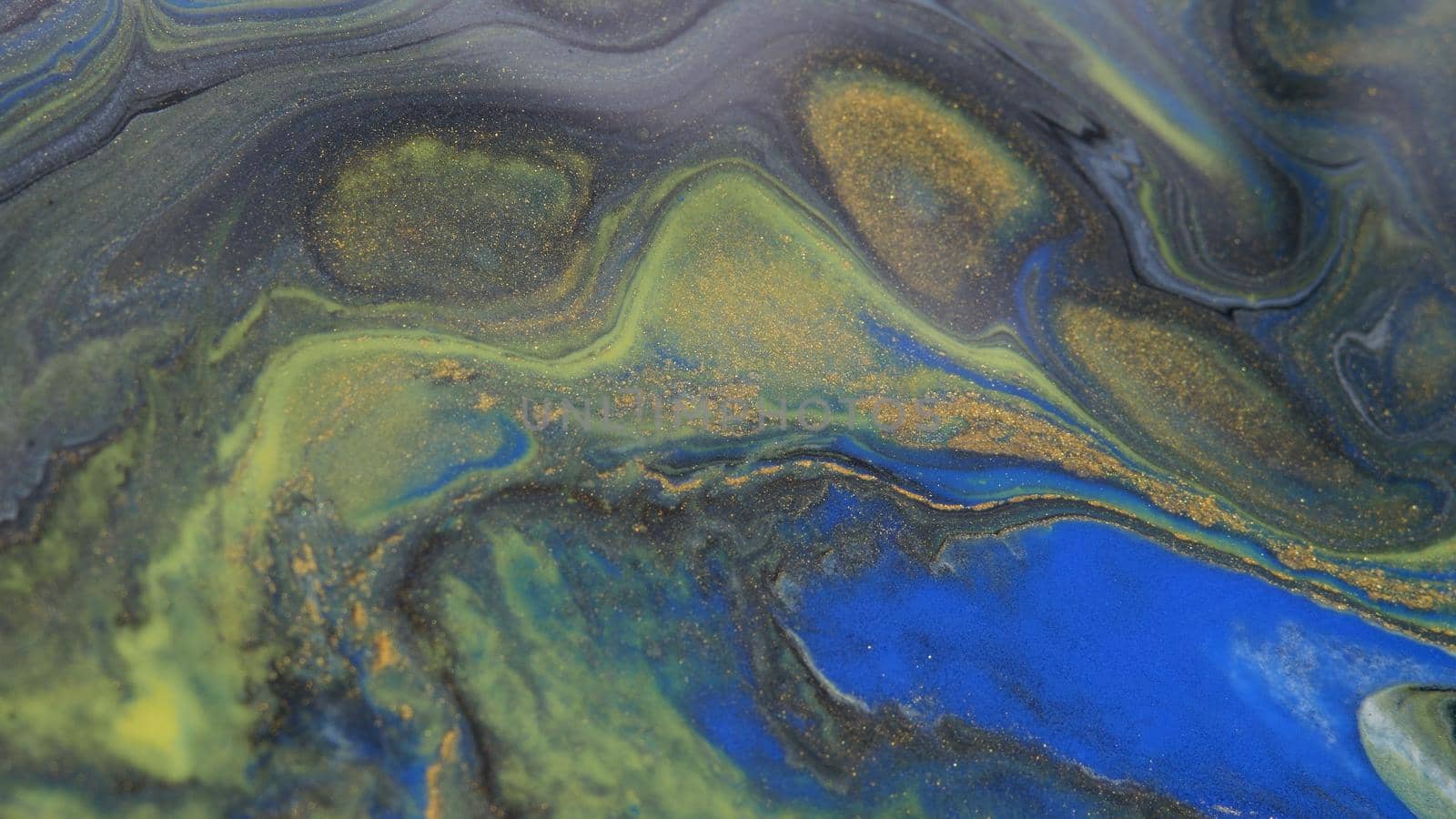 Abstract colorful background of spreading colors. Abstract dark paint background. Acrylic texture with marble pattern. Abstract-ART. Natural luxury. The style includes the vortices of marble or the ripples. Very beautiful blue, black, red, yellow, gray paint with the addition of gold powder.