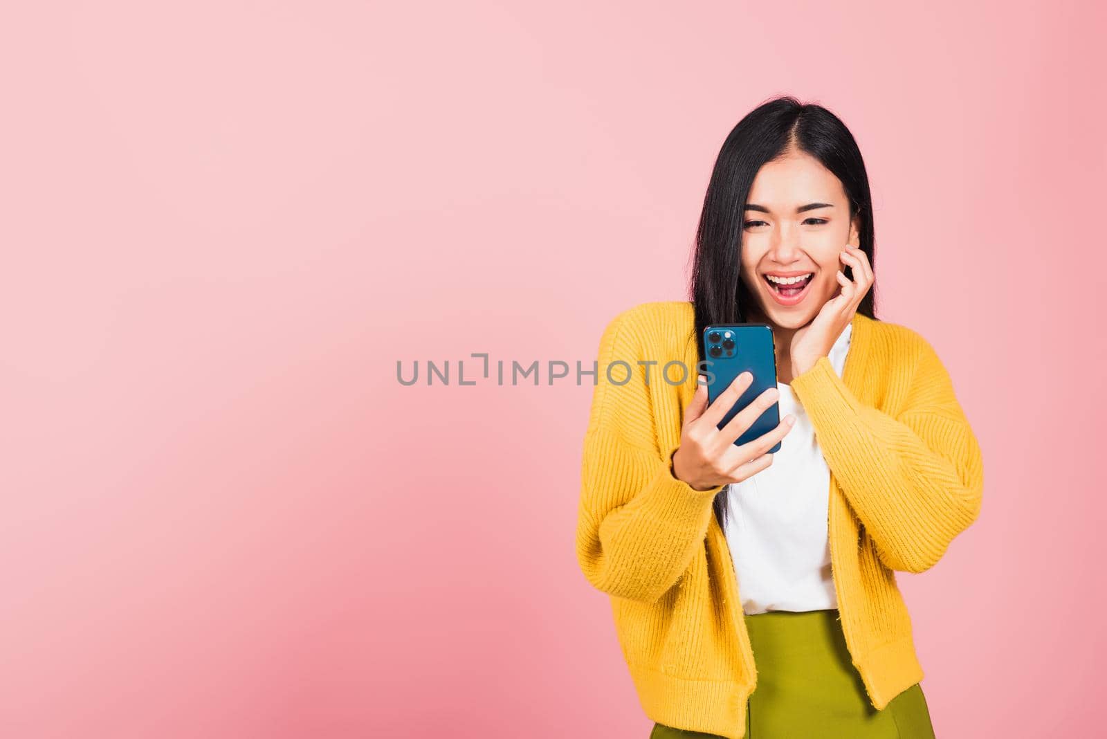 woman teen smiling excited using smart mobile phone by Sorapop