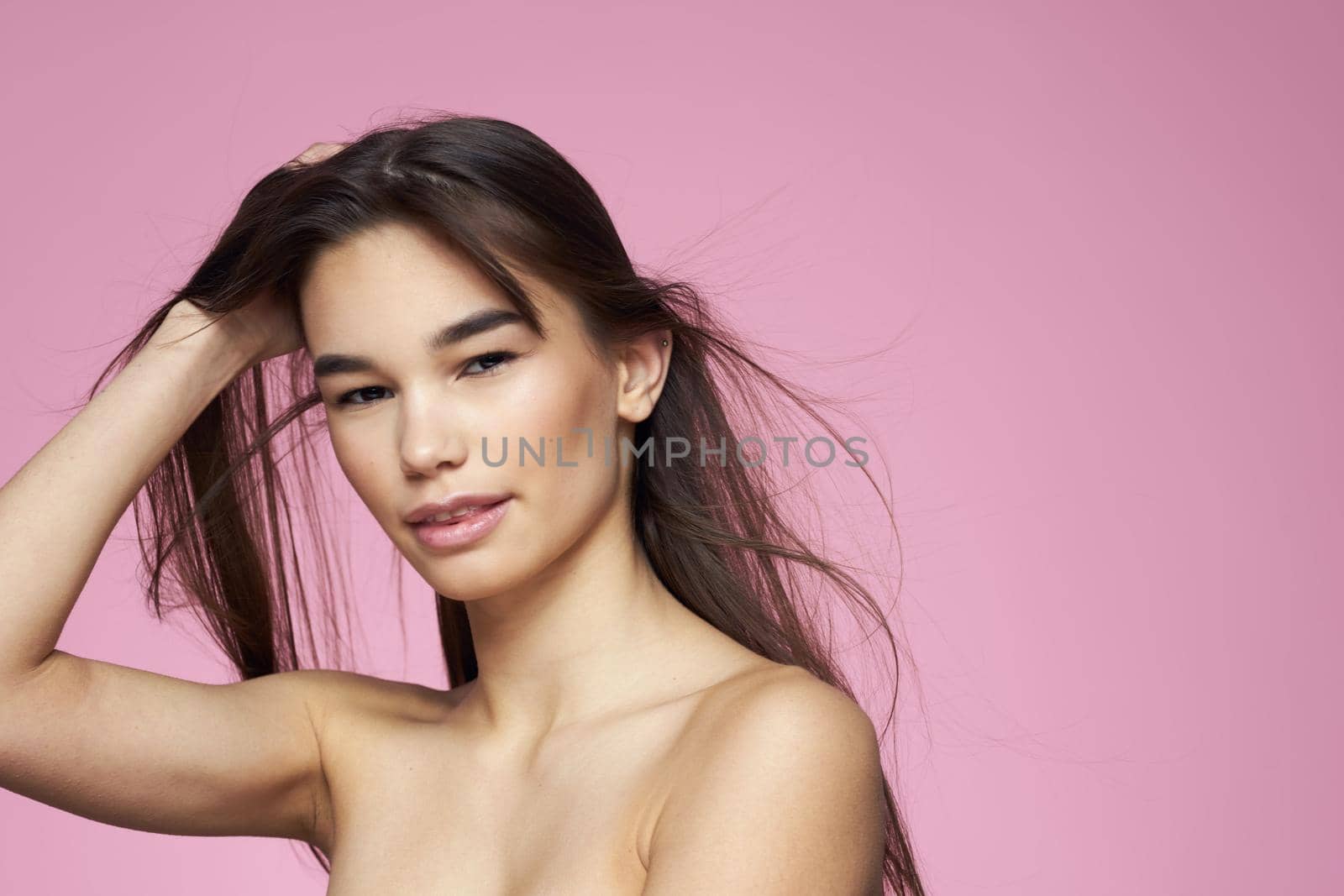 brunette bare shoulders clear skin body care pink background by SHOTPRIME