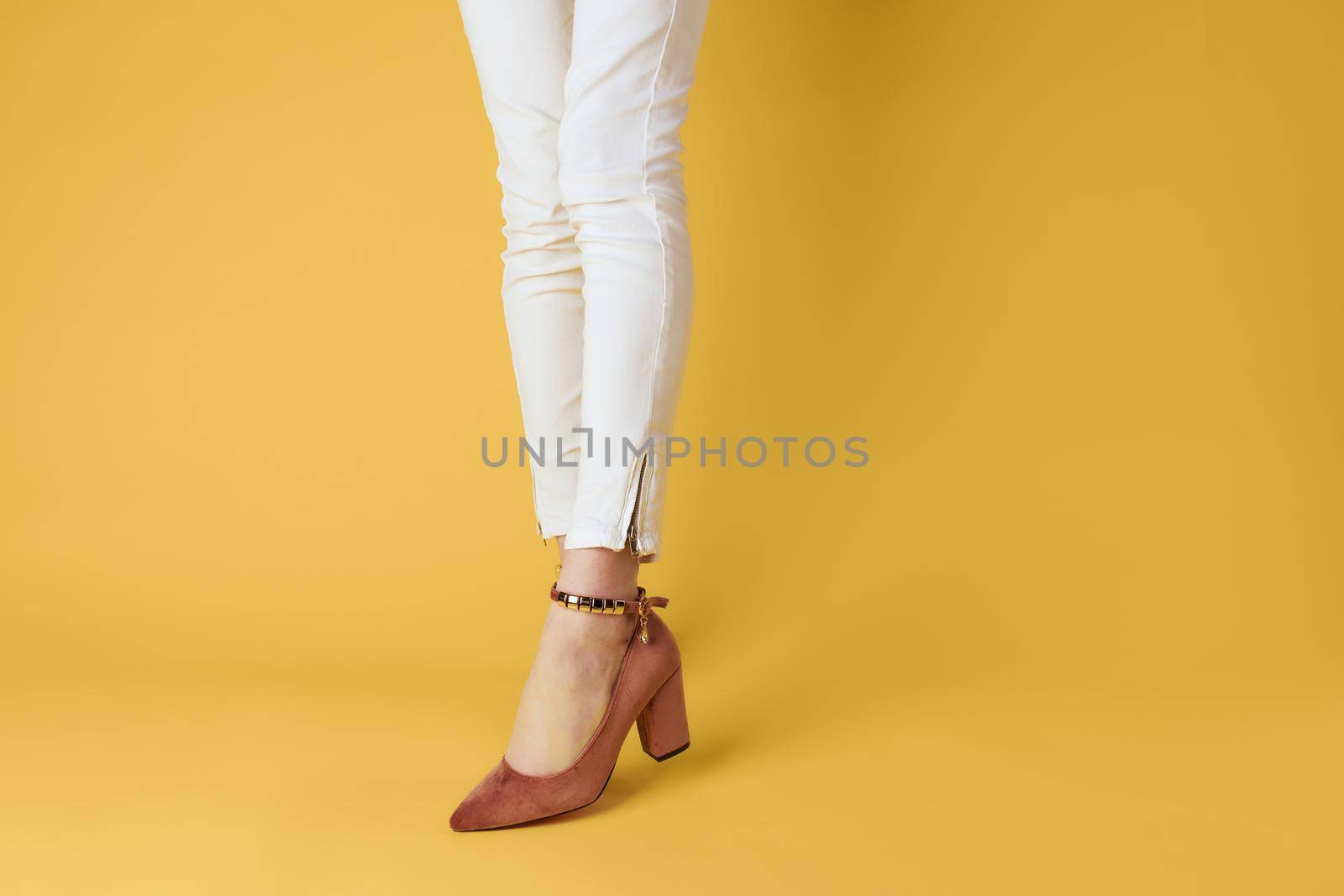 Female feet fashionable shoes luxury yellow background elegant style. High quality photo