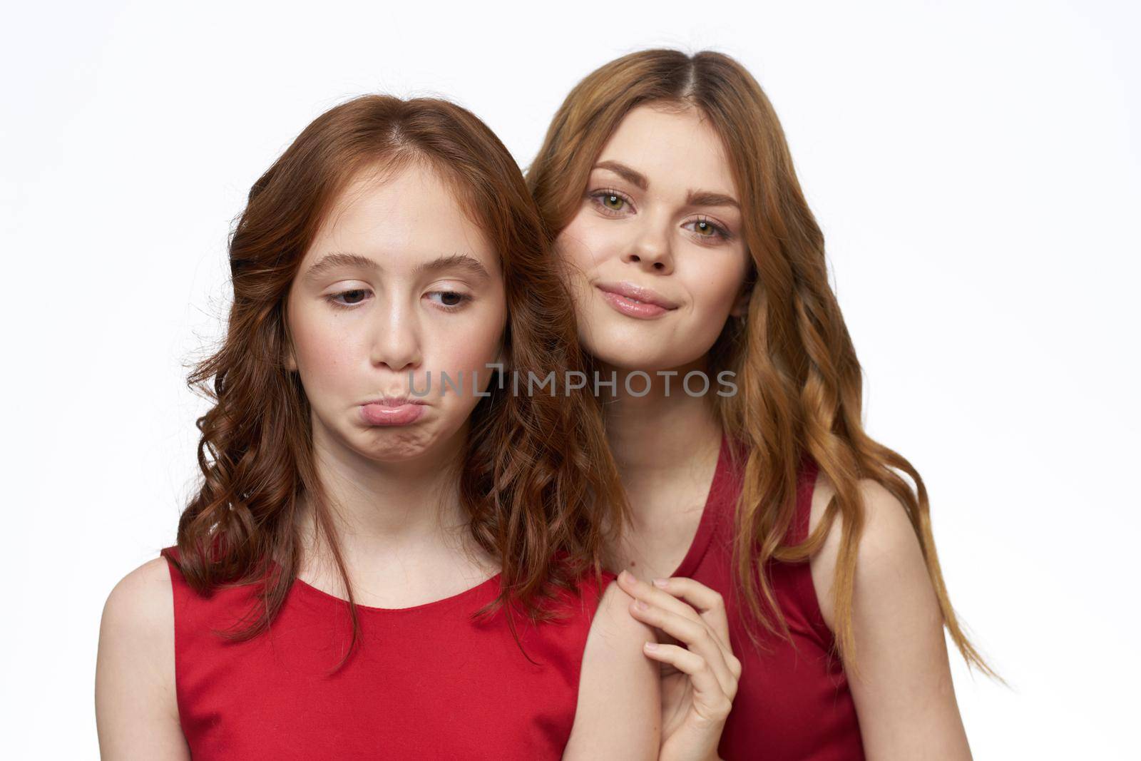 Mom and daughter red dress hug family joy friendship. High quality photo