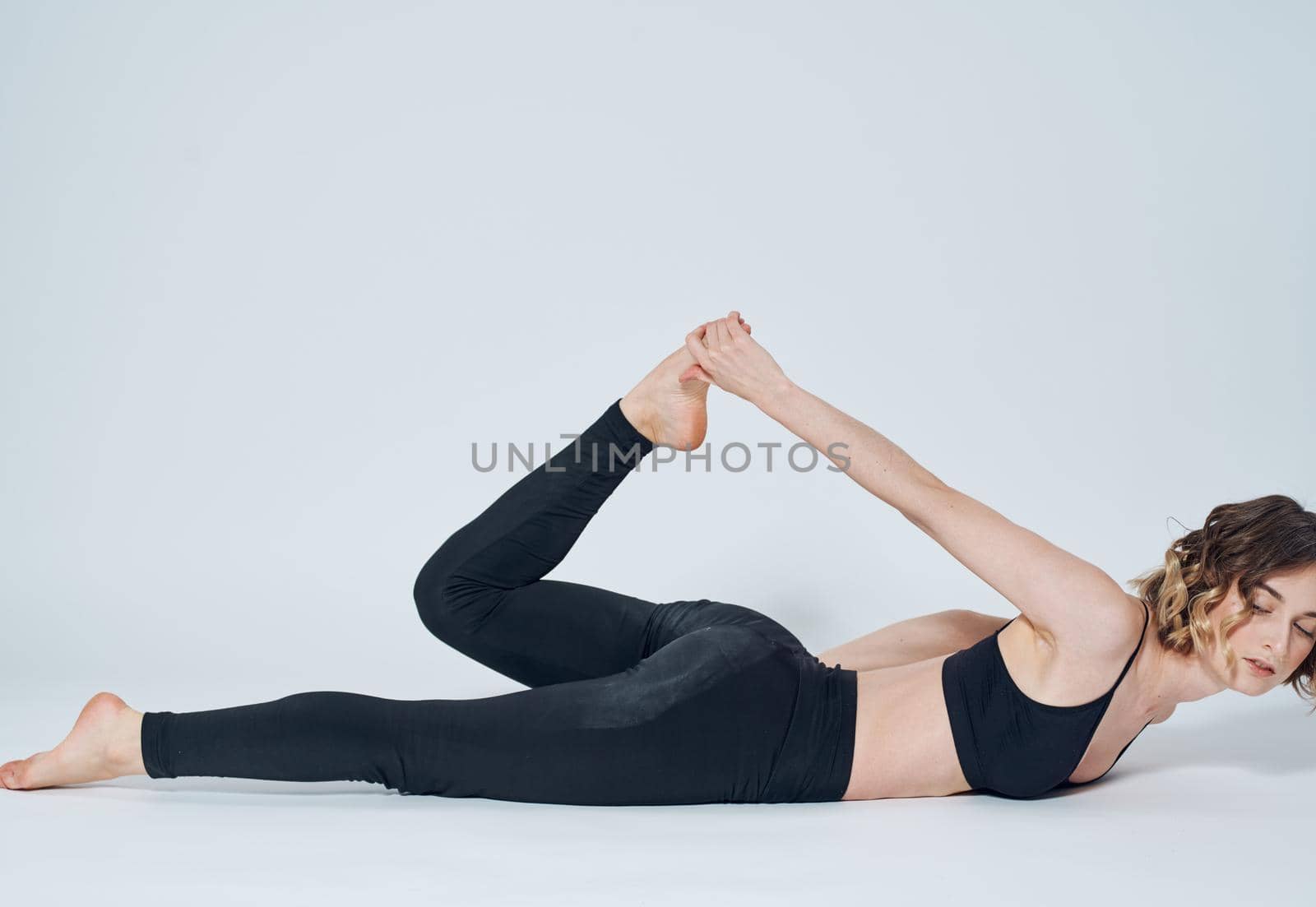 Women lies on the floor In a light room, sport yoga asanas by SHOTPRIME