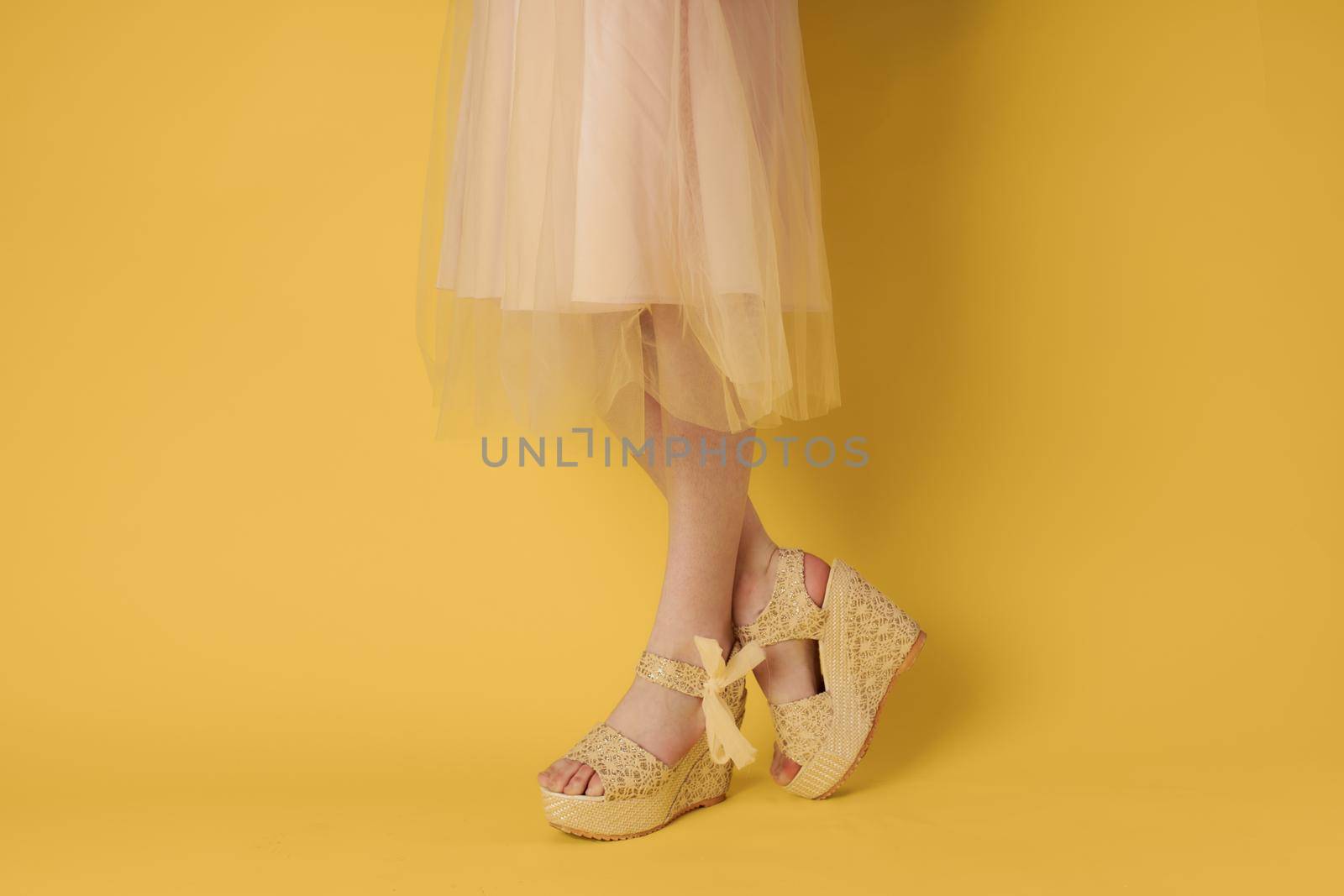 Womens feet fashionable shoes clothes yellow background elegant style. High quality photo